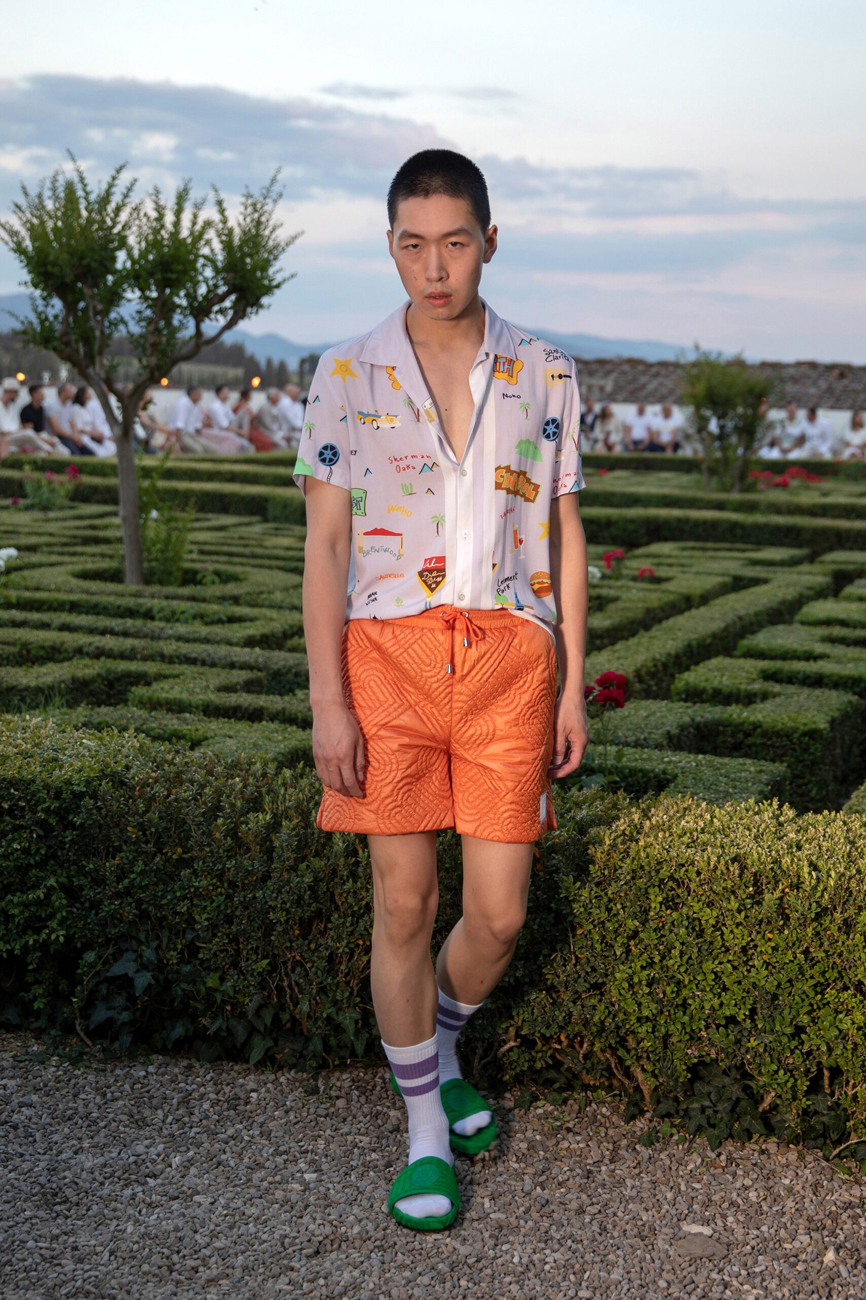 relaxed white printed shirt and orange shorts
