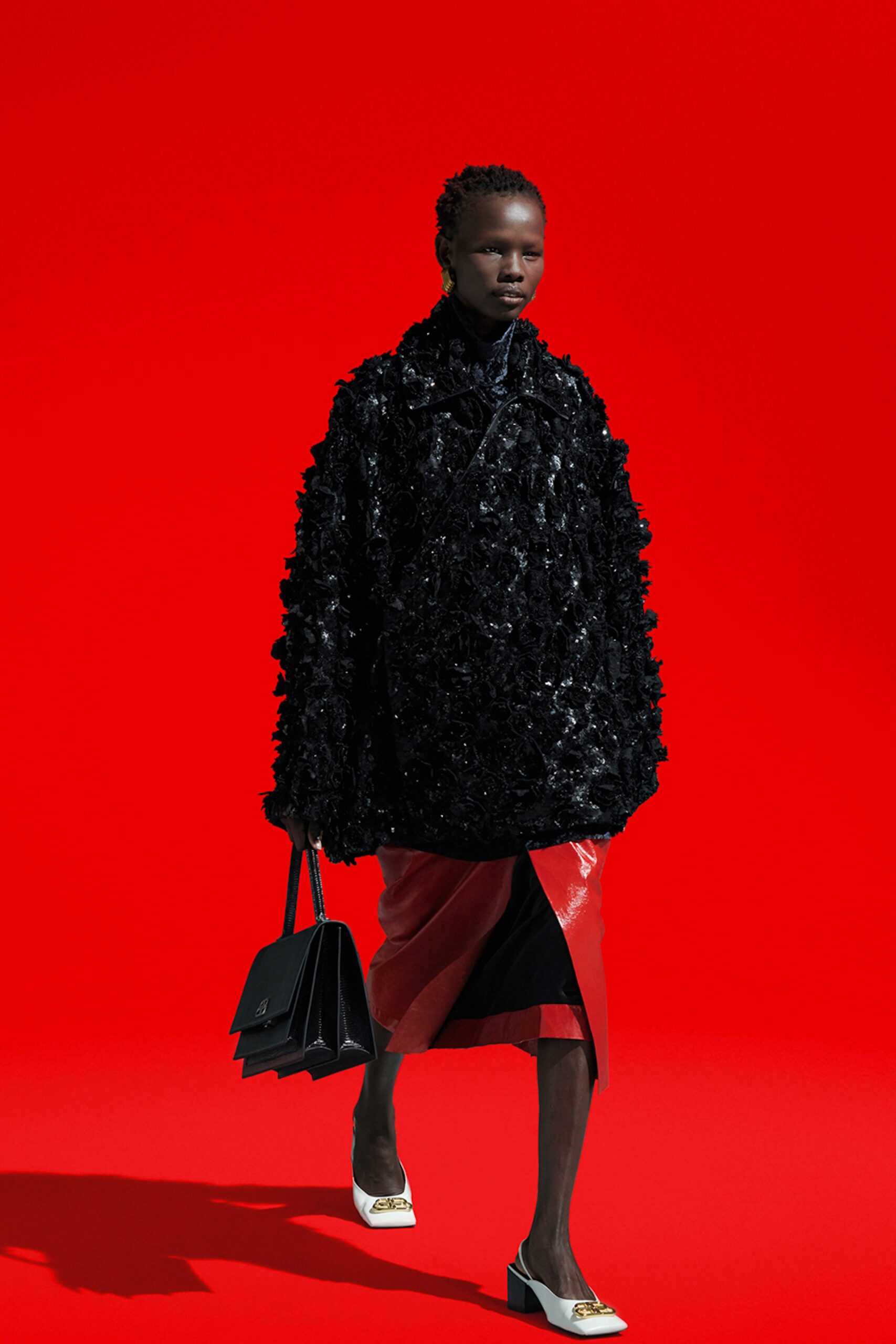 black fur oversized coat and red leather skirt