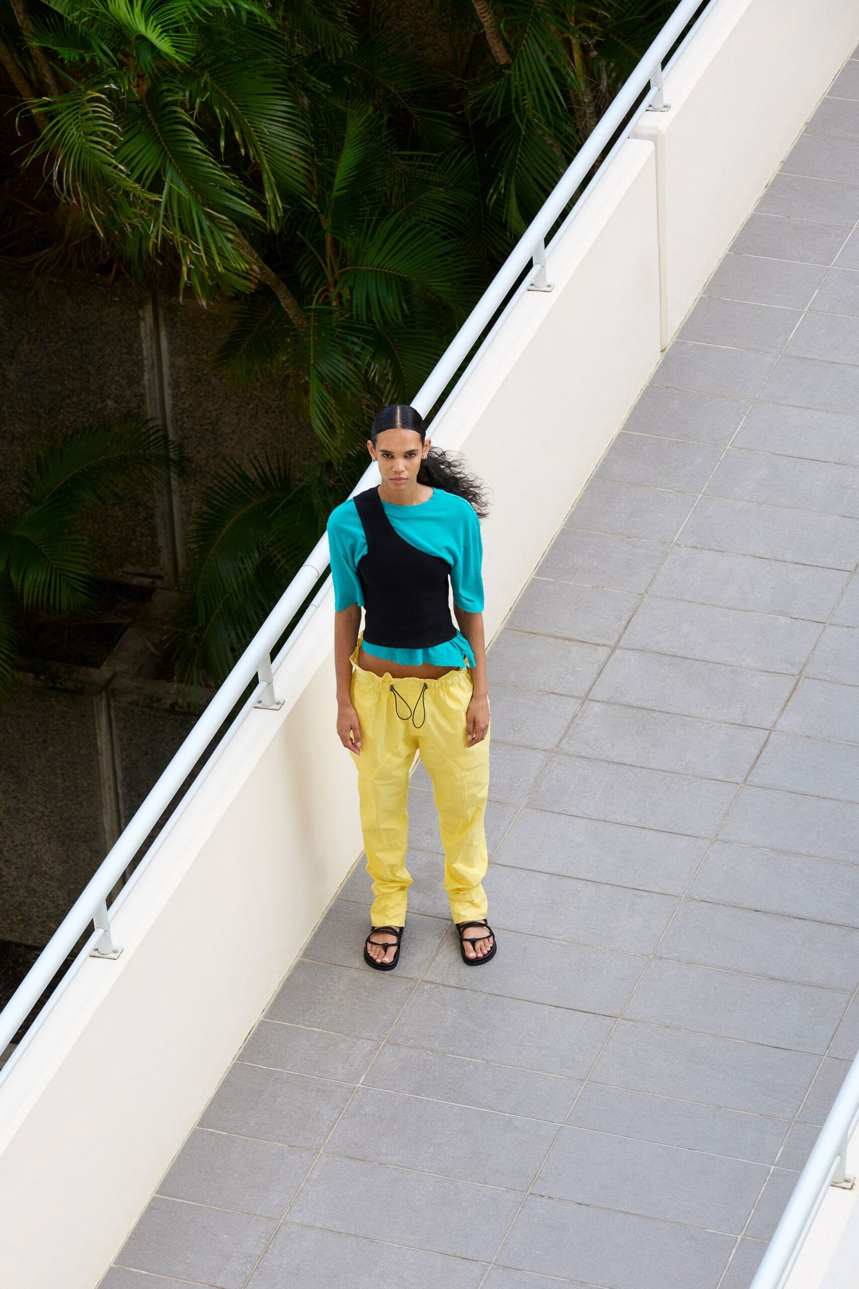 teal asymmetric top with yellow cargo pants