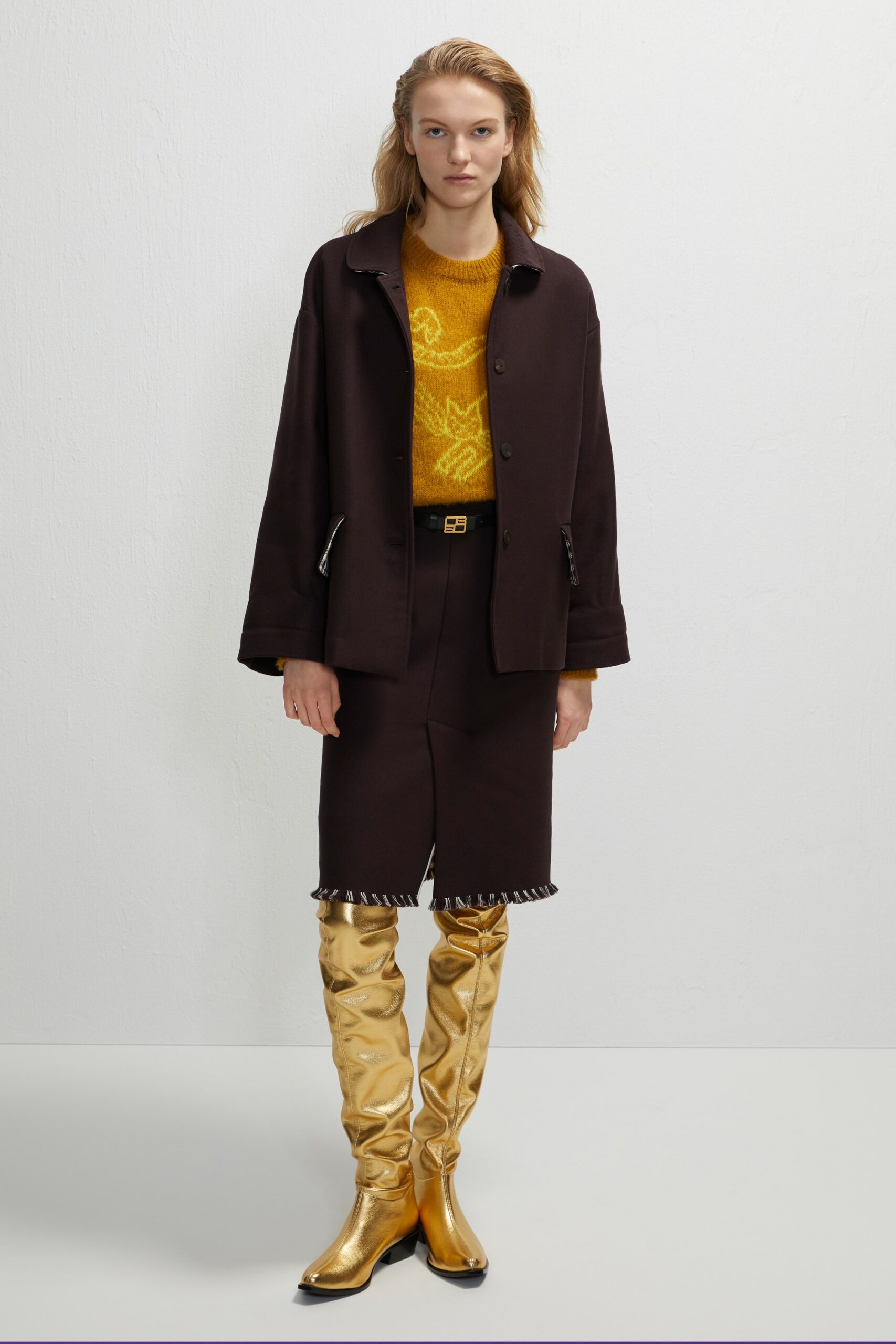 black jacket yellow sweater black skirt gold boots