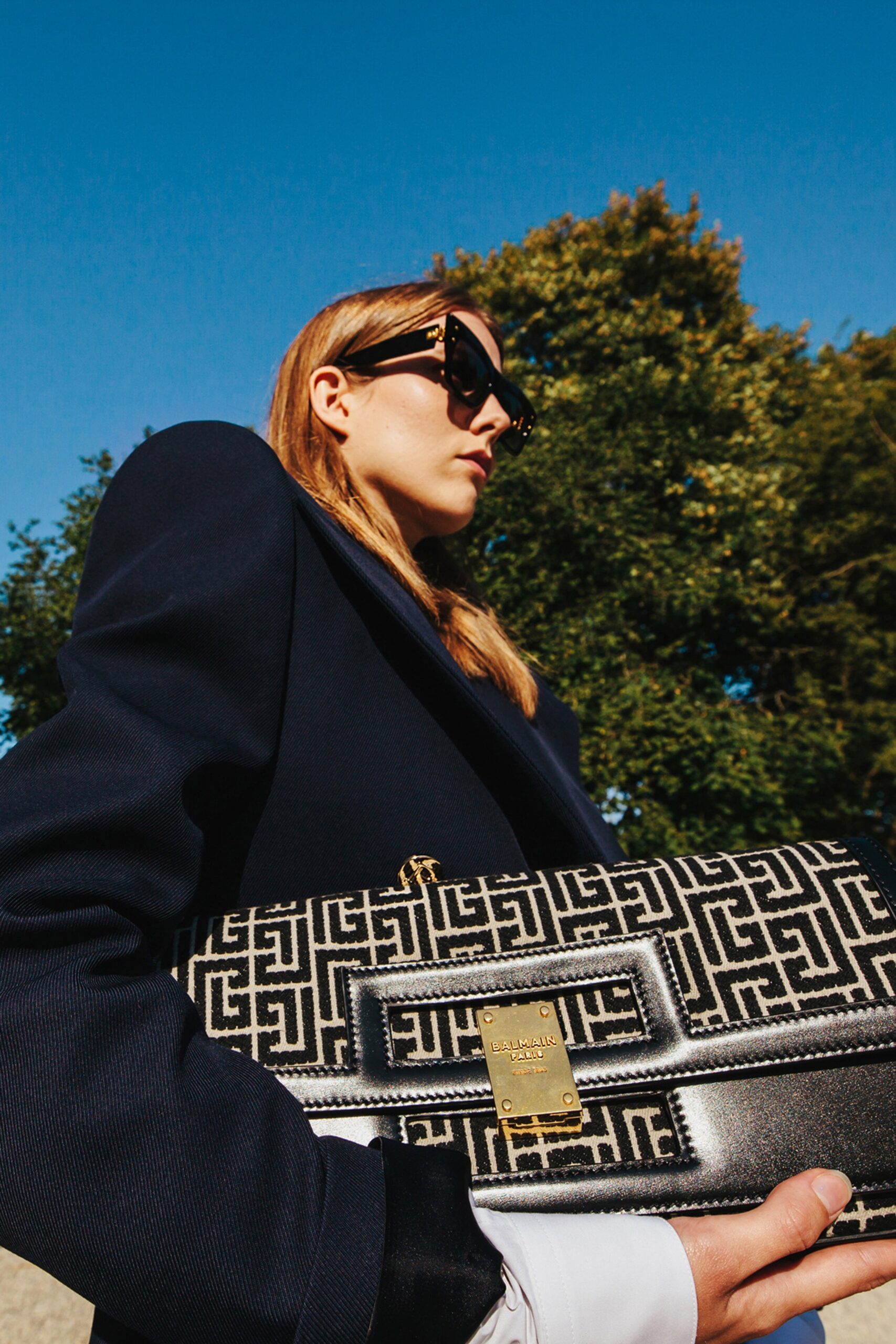 black structured blazer with printed bag