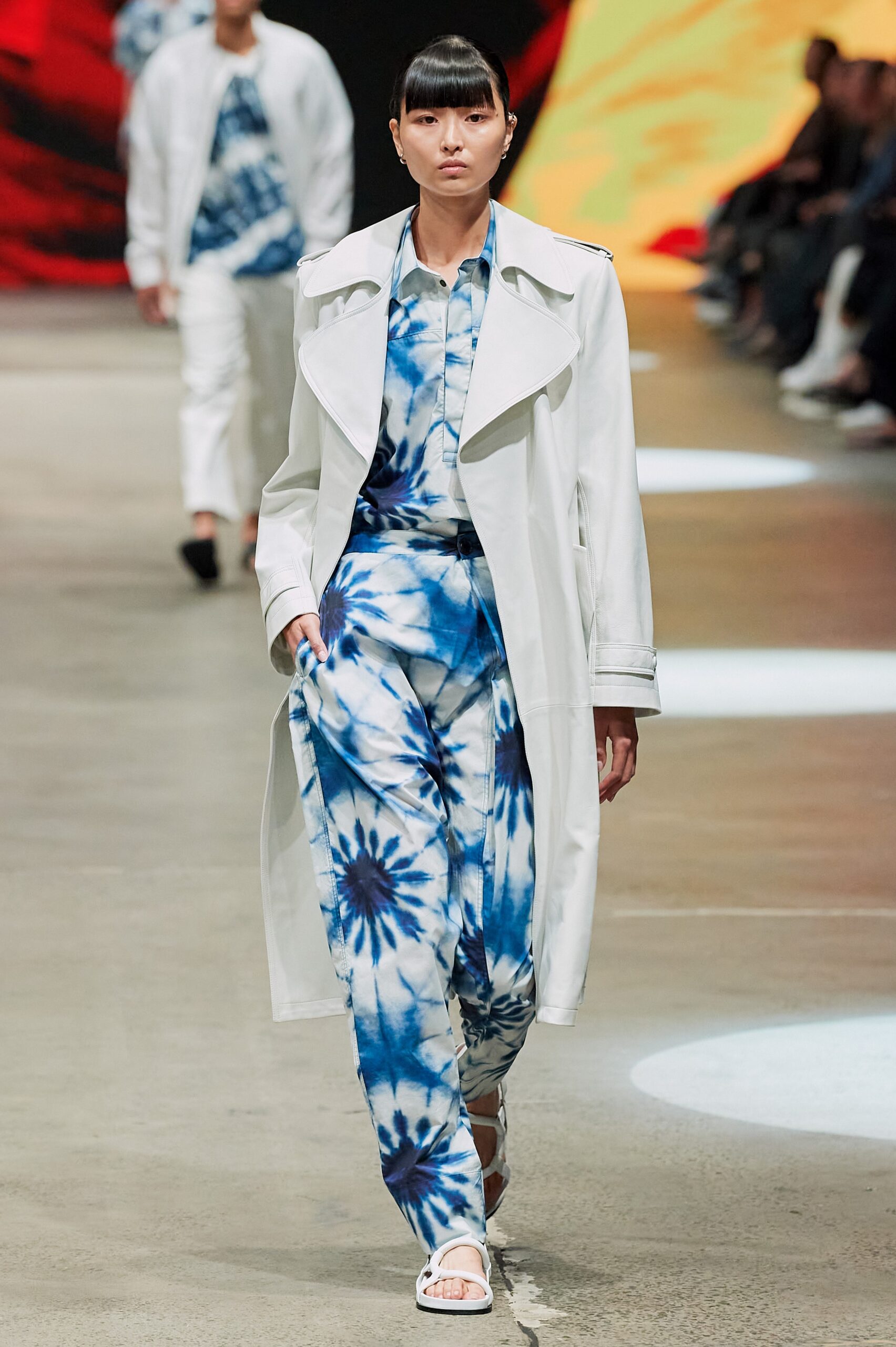 white trench coat and blue printed jumpsuit