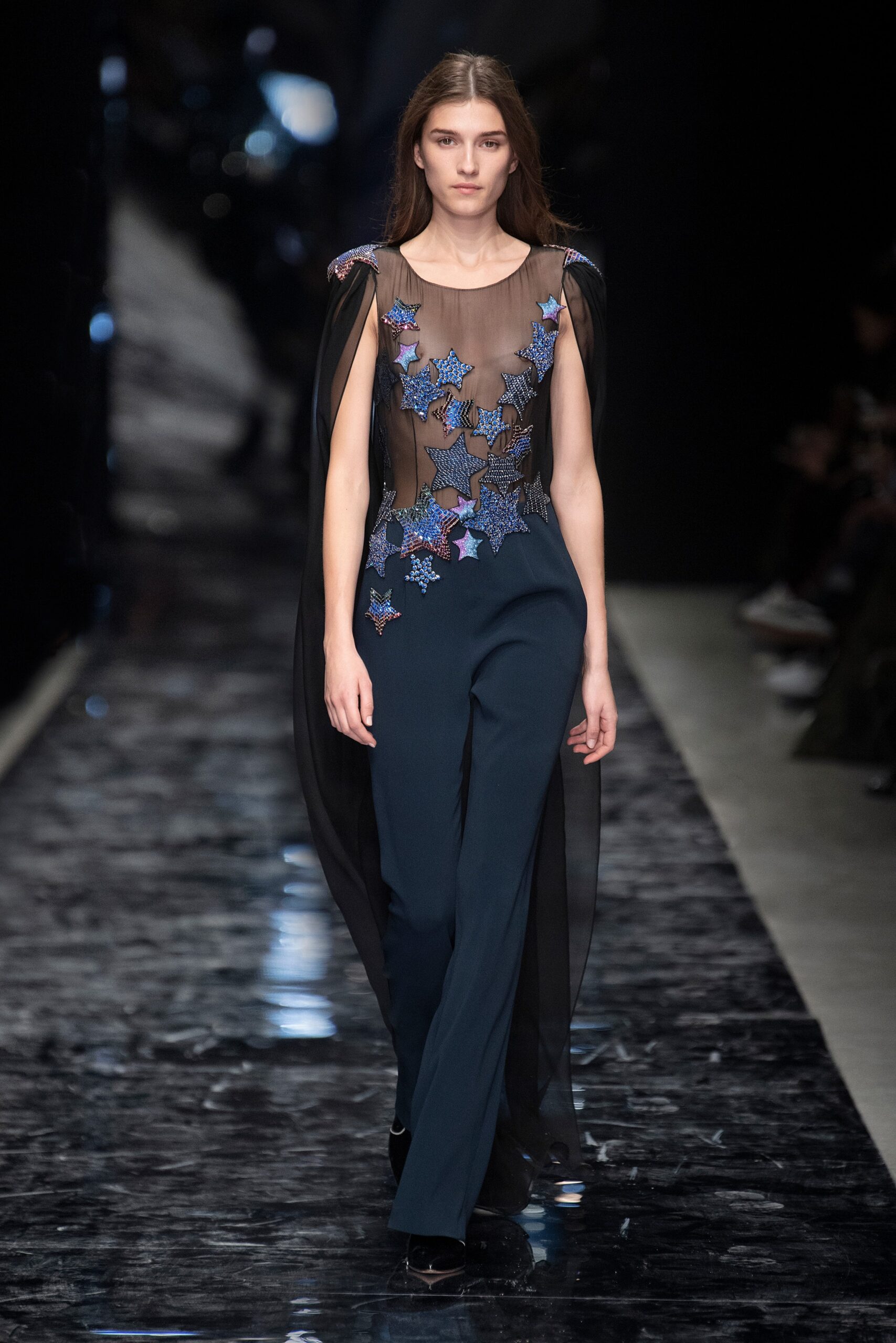 blue silk fitted jumpsuit with black cape