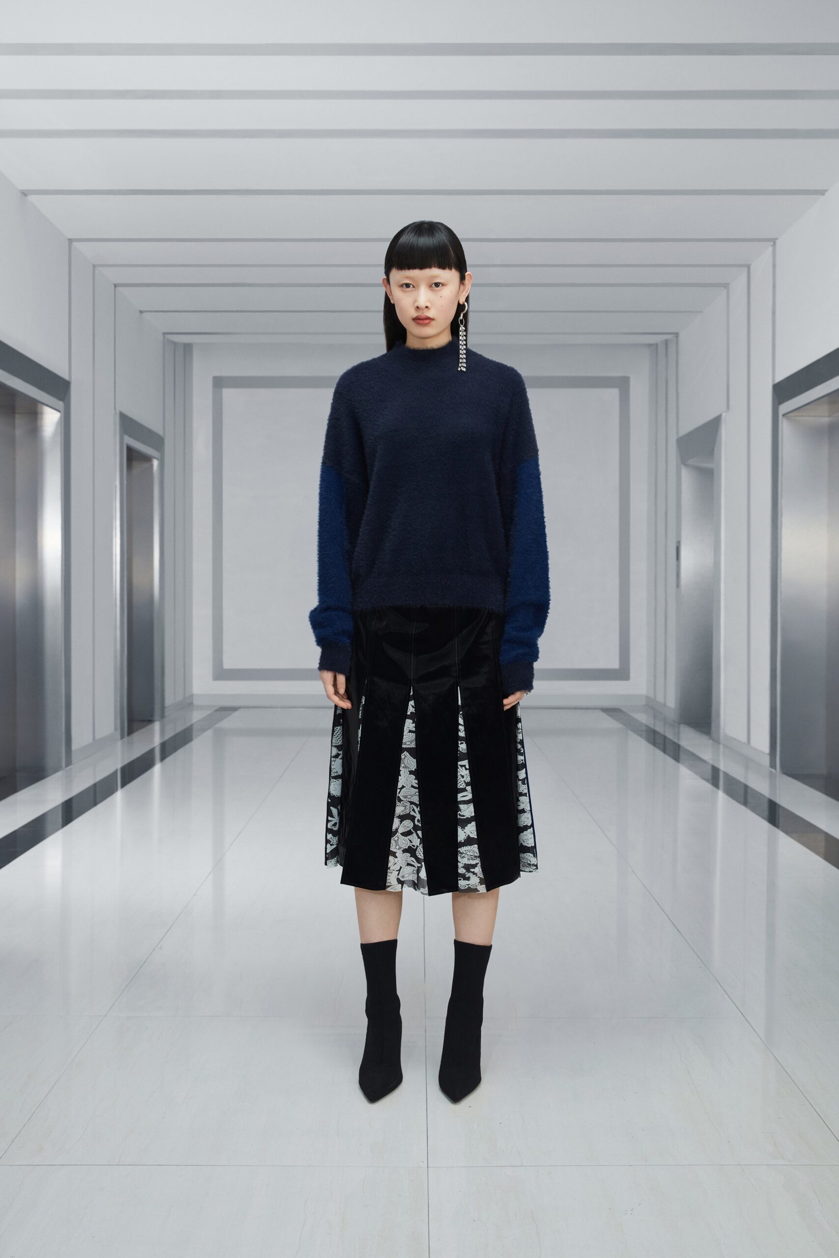 blue wool relaxed sweater and pleated skirt