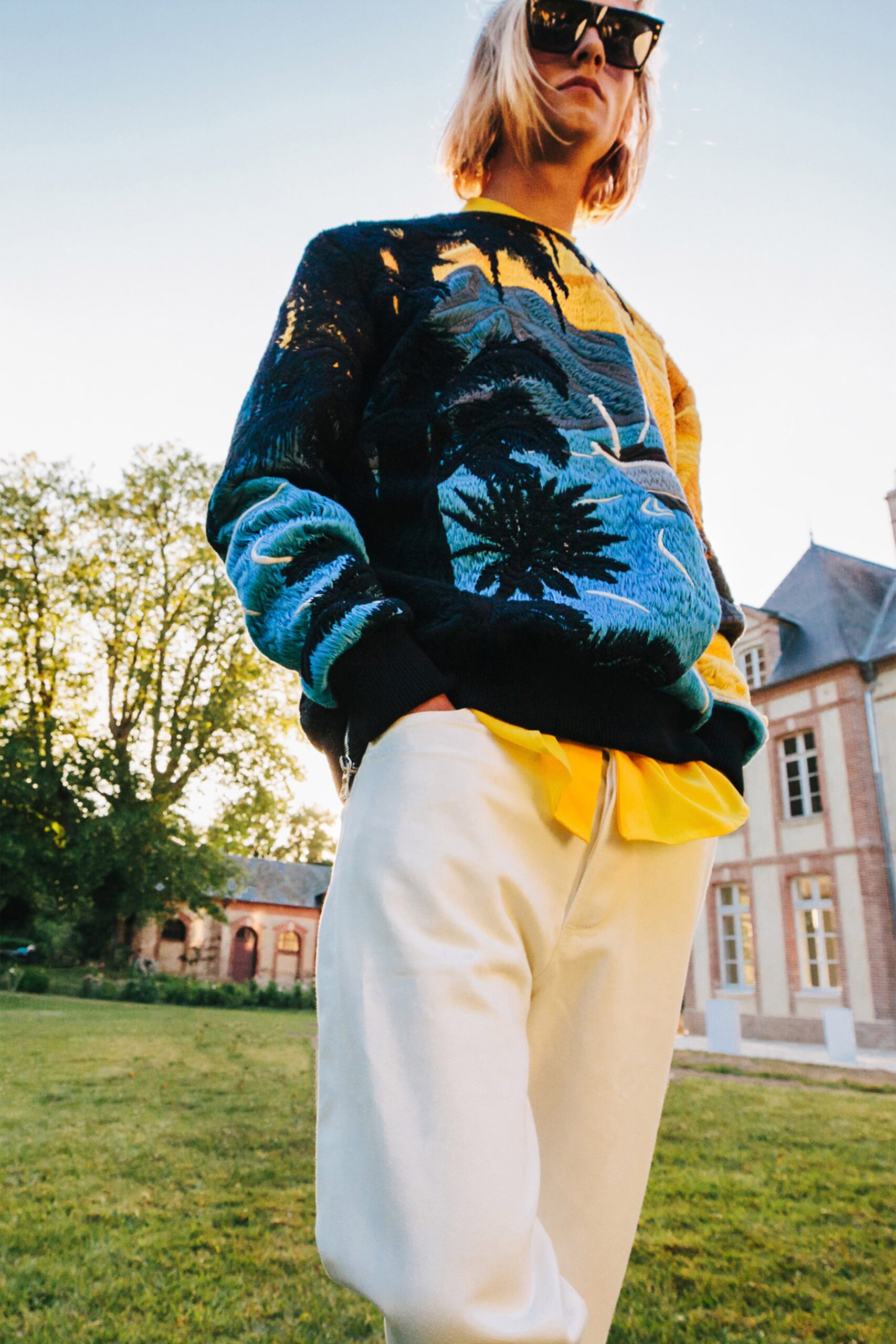 relaxed black printed sweater with white pants