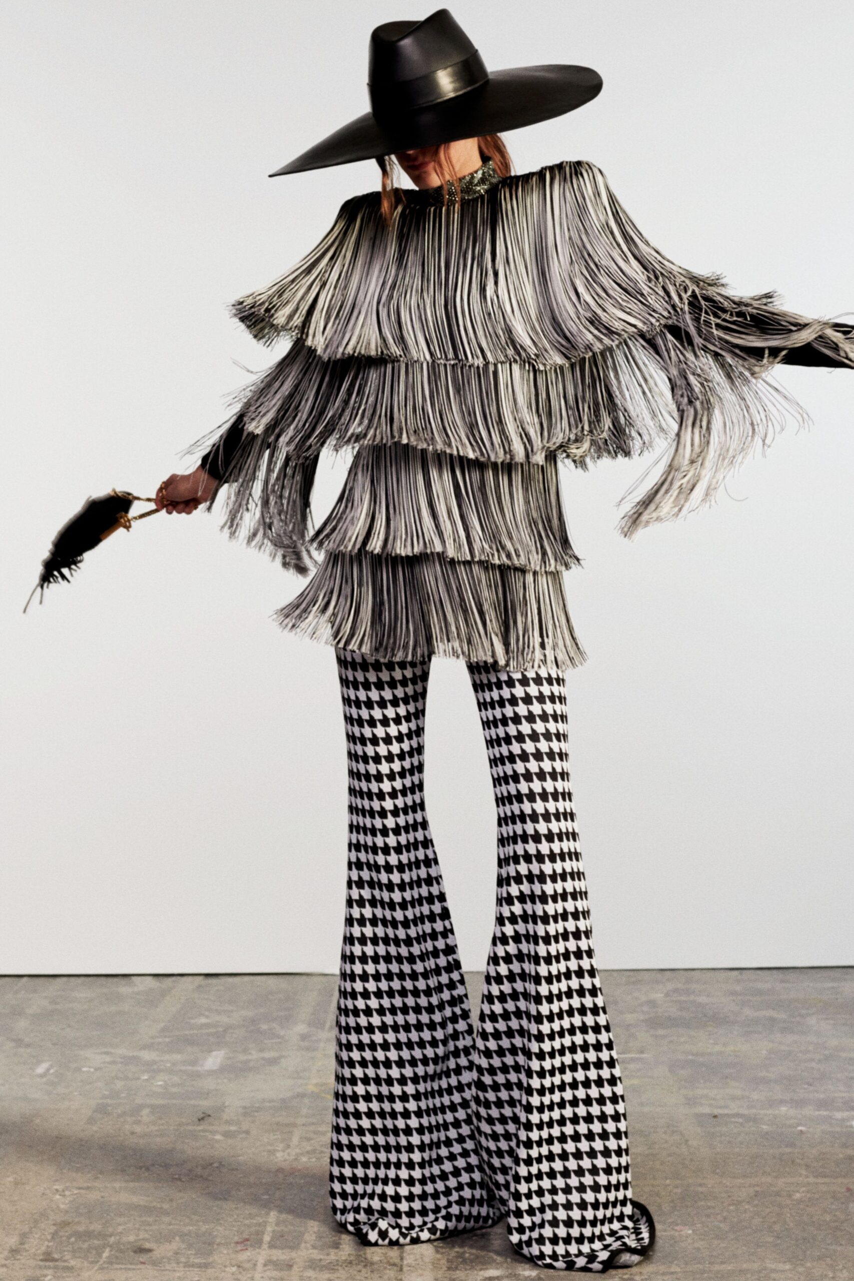 fringed black and white top with flared pants