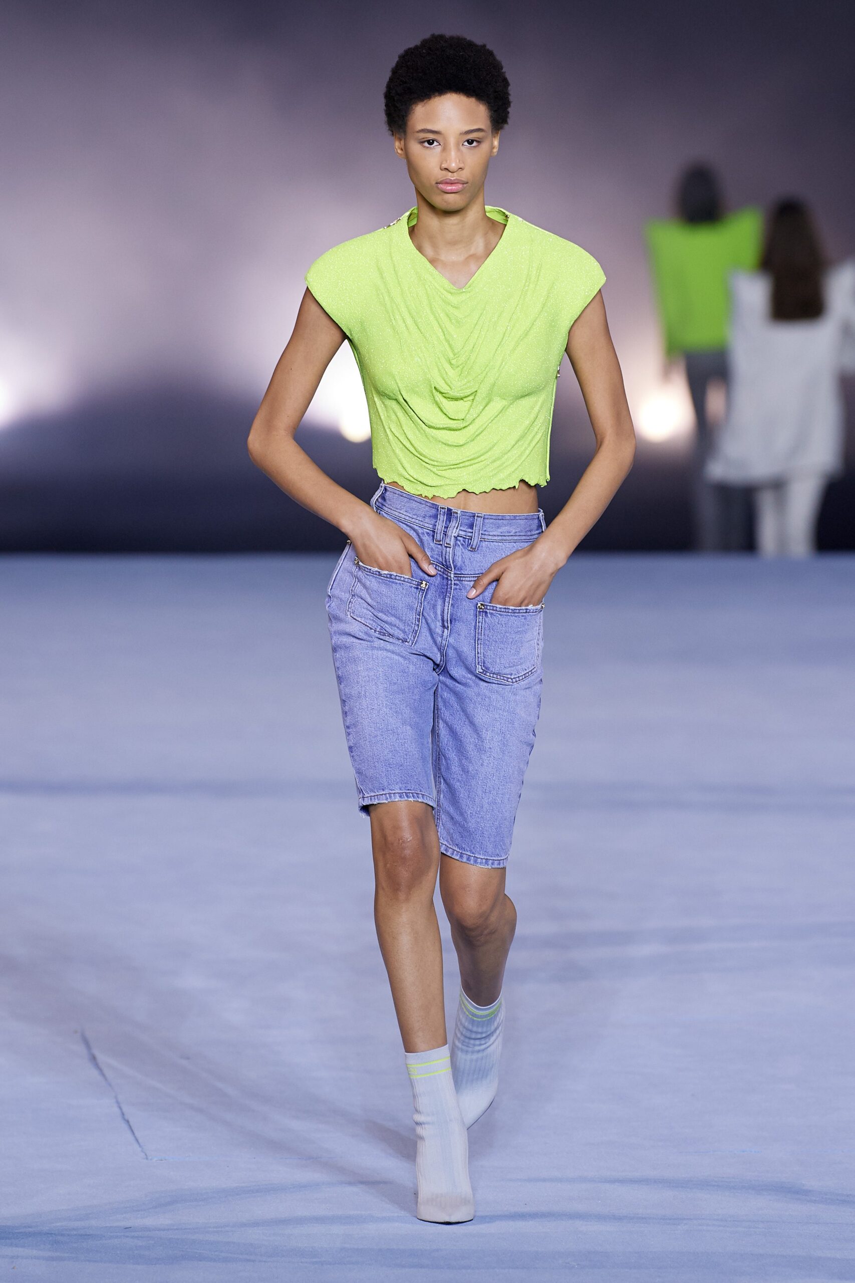 green fitted top with denim shorts