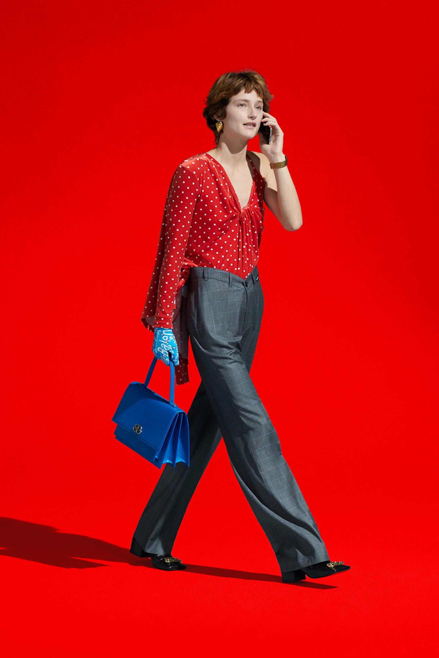 red polka-dot blouse with gray pants