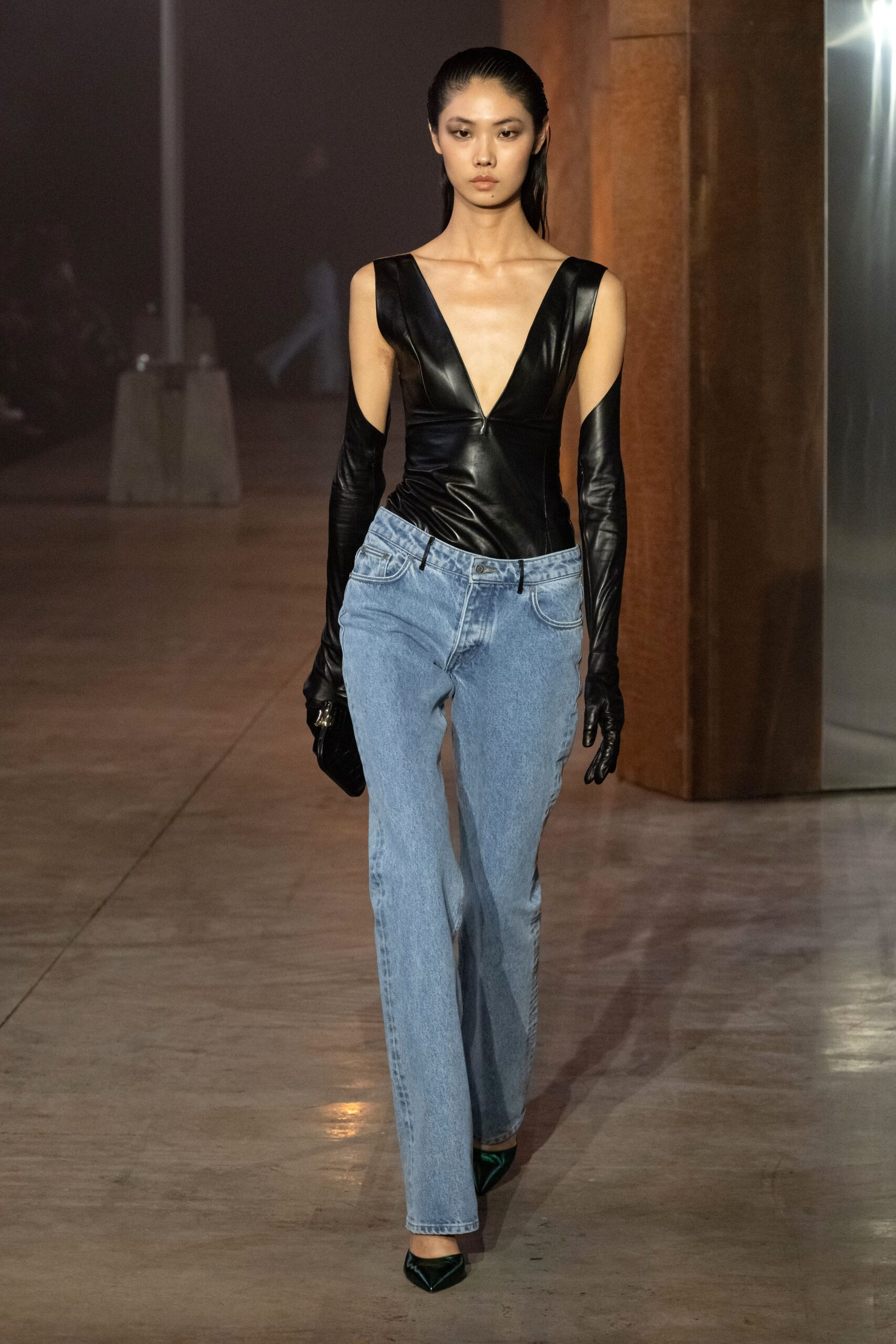 black leather sleeveless top with denim pants