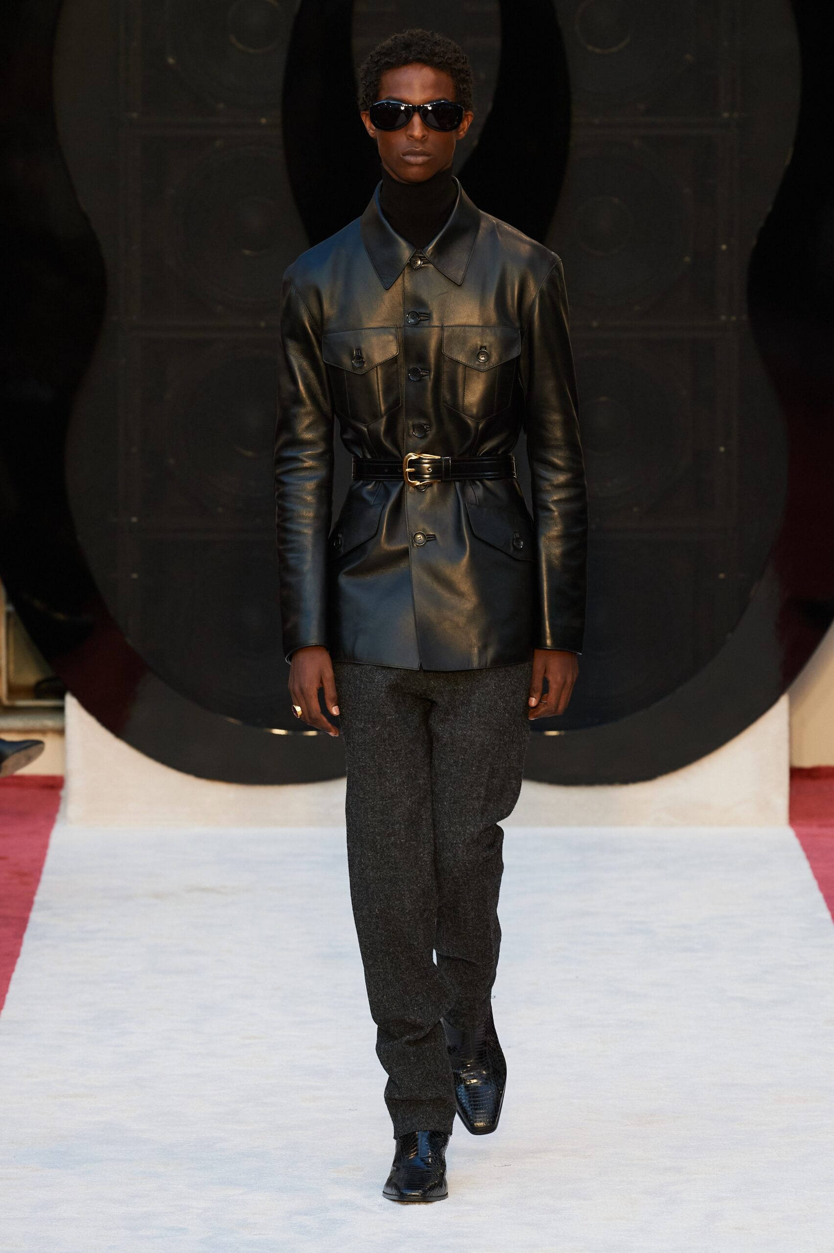 black leather fitted jacket and gray tailored pants