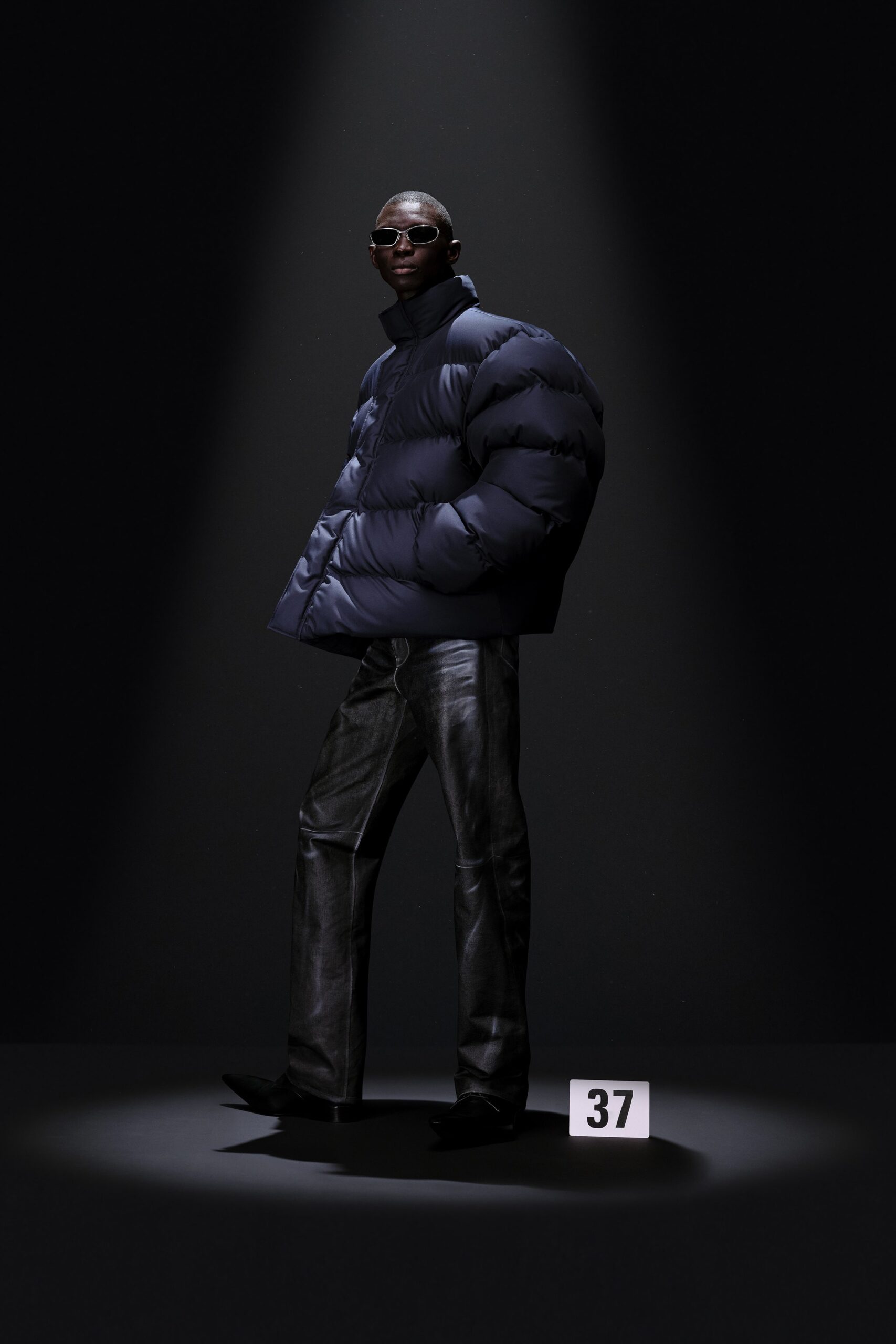 oversized blue vinyl jacket and black leather pants