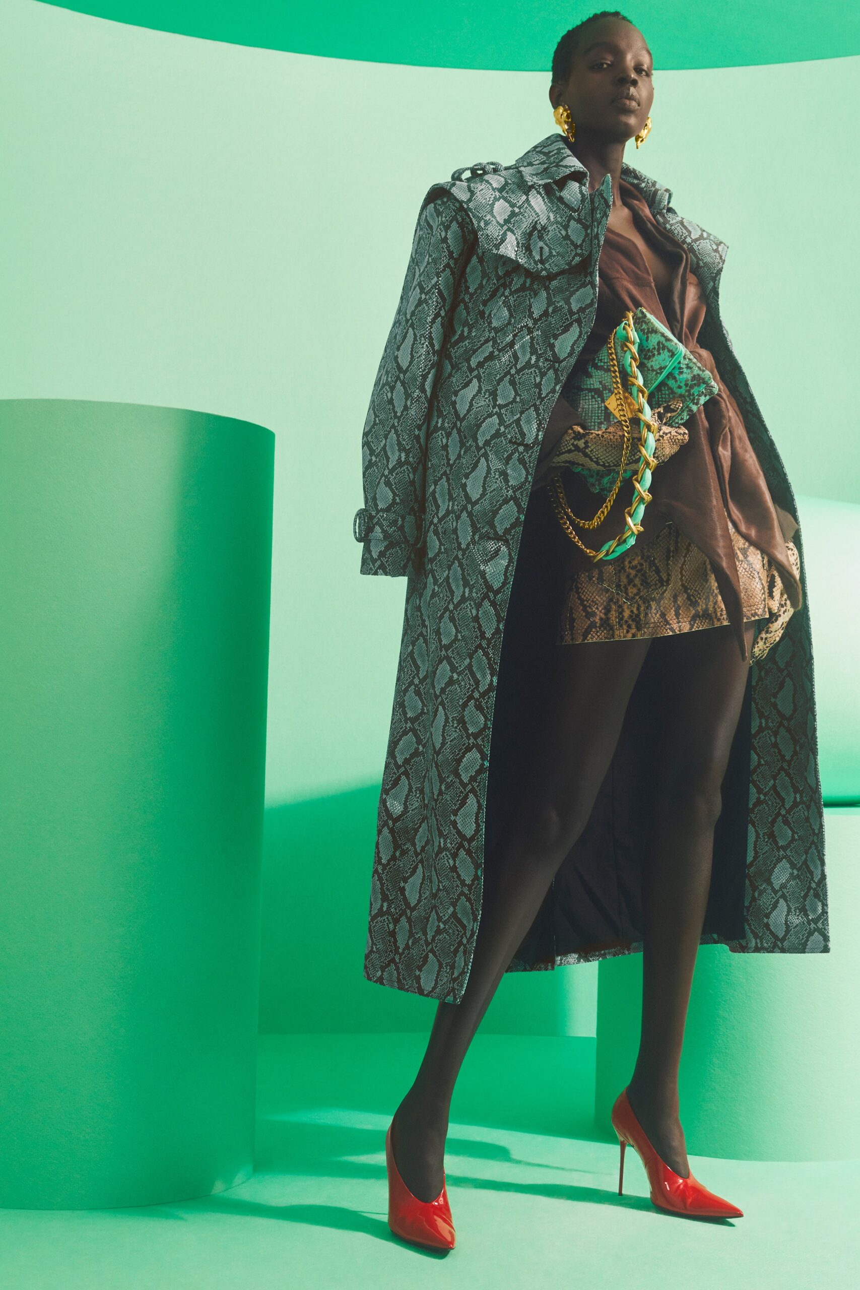 green printed coat and brown mini dress