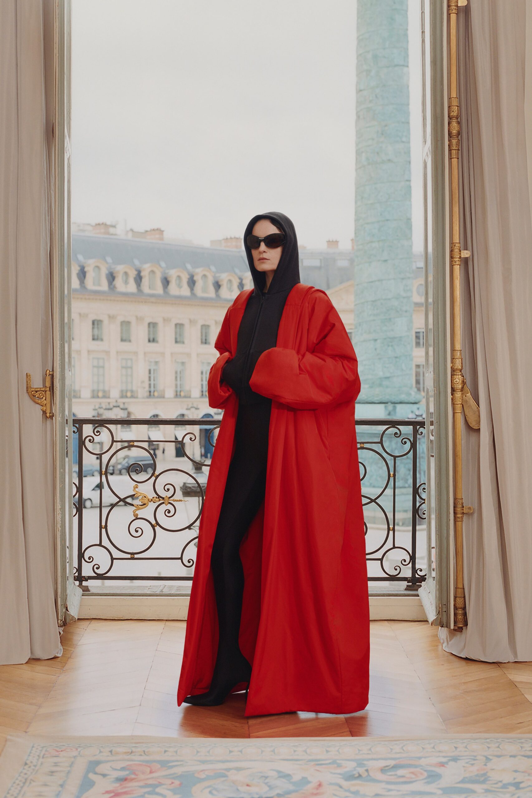 red oversized coat with black catsuit