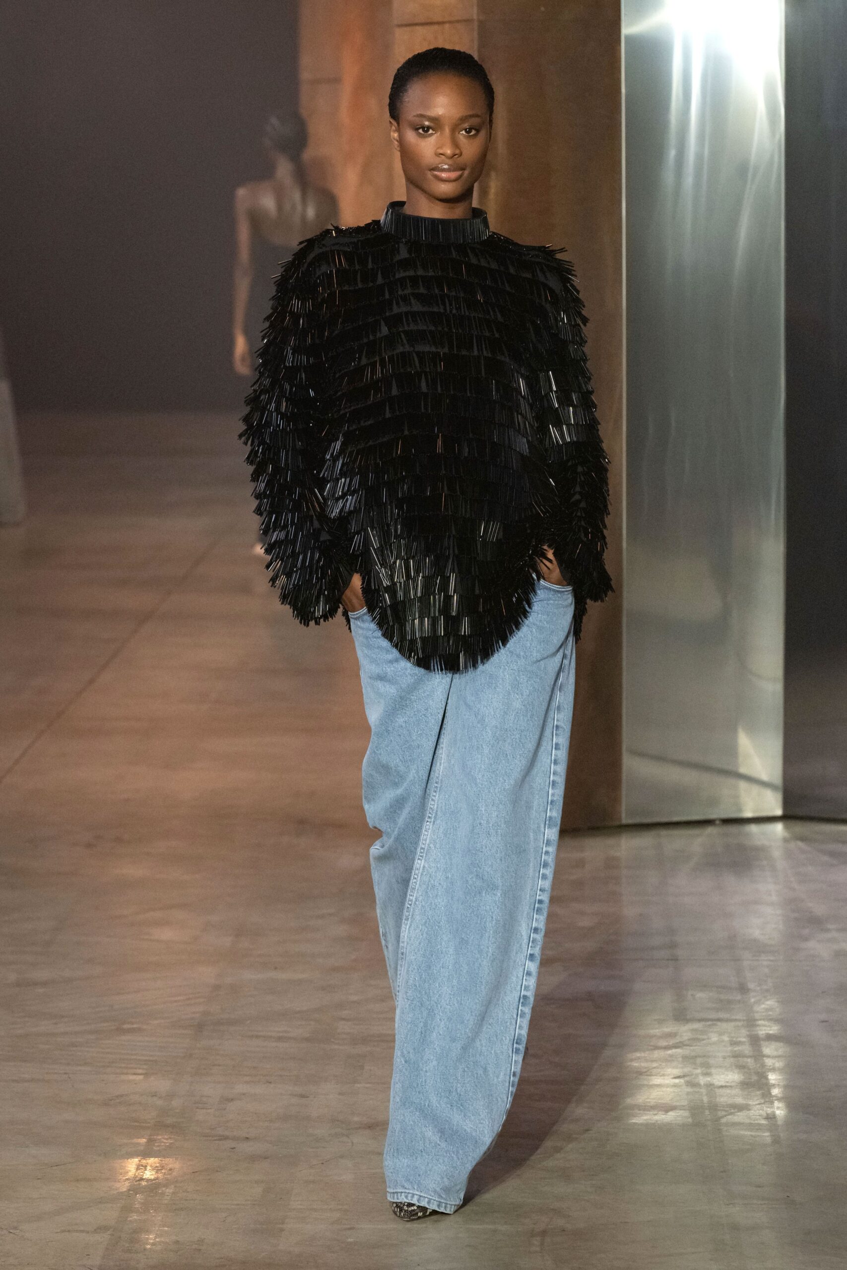 black fringed top with denim pants