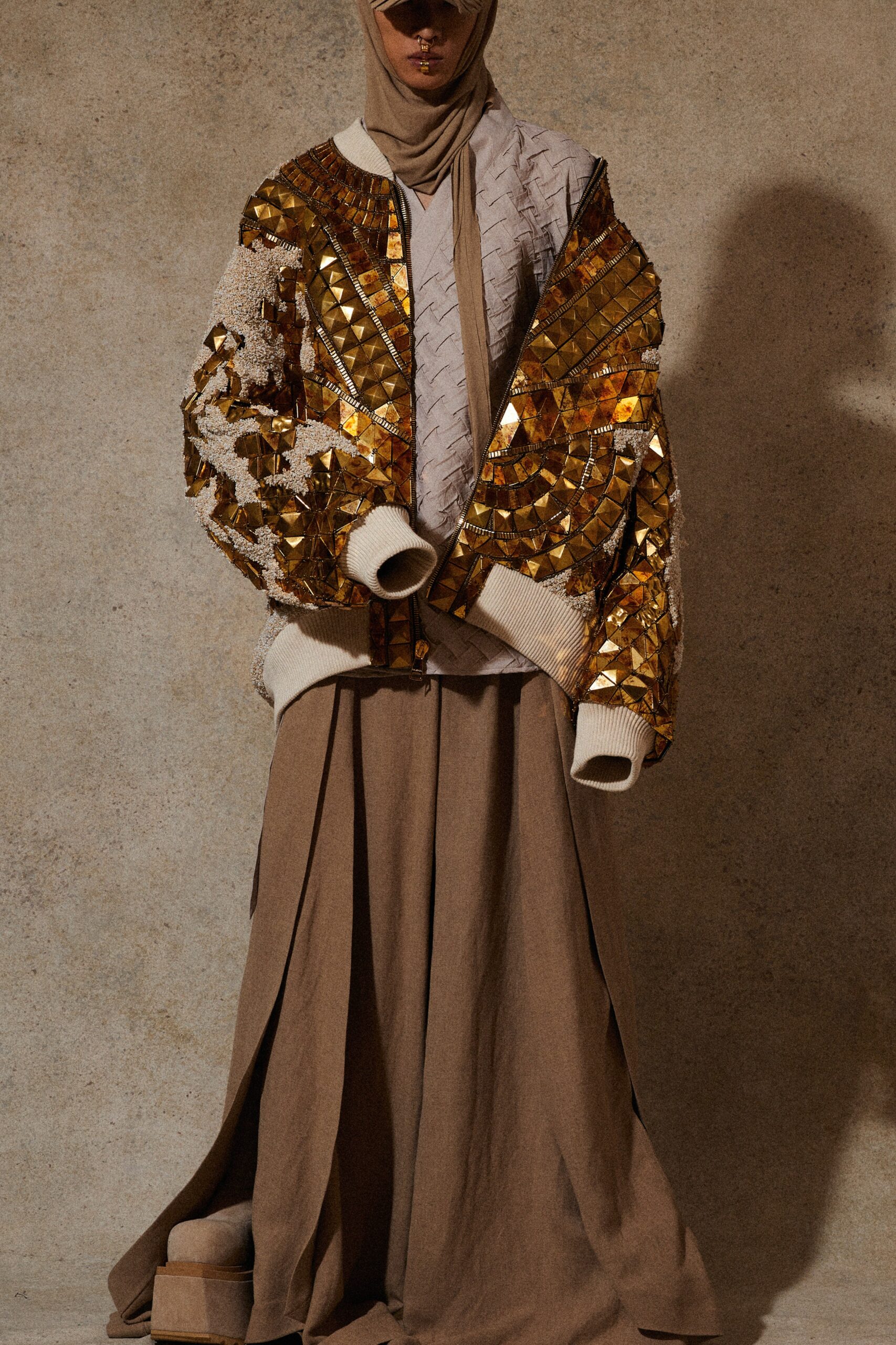 gold embellished jacket and brown skirt