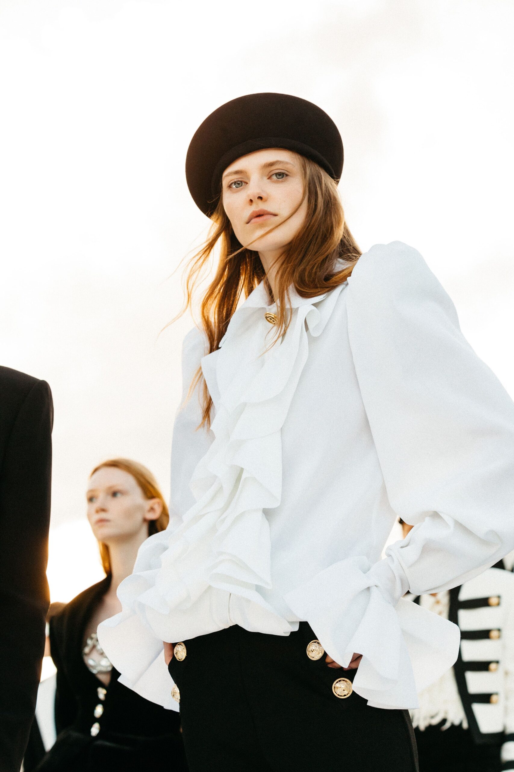white ruffled blouse with black pants