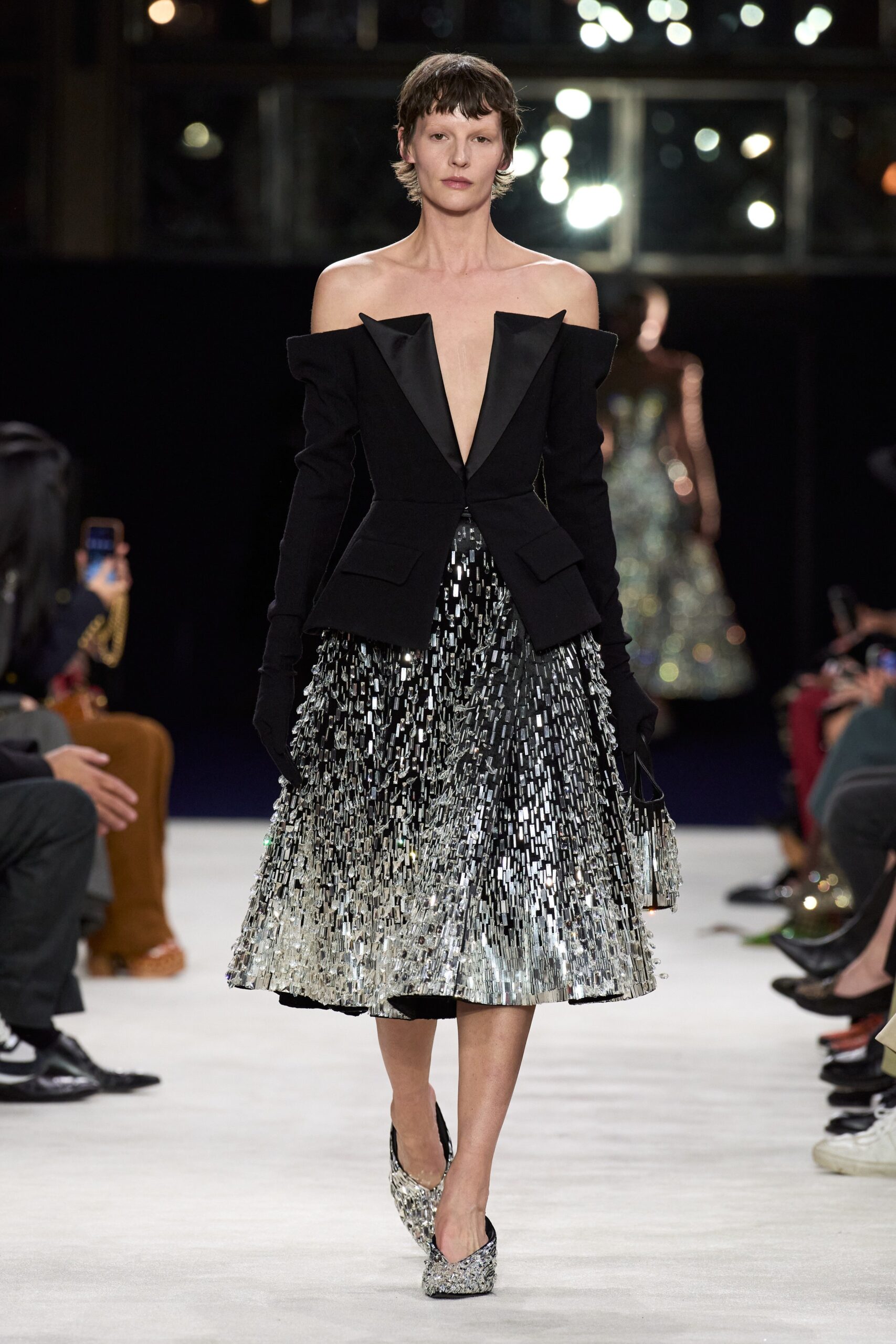 black silk fitted blazer and silver pleated skirt