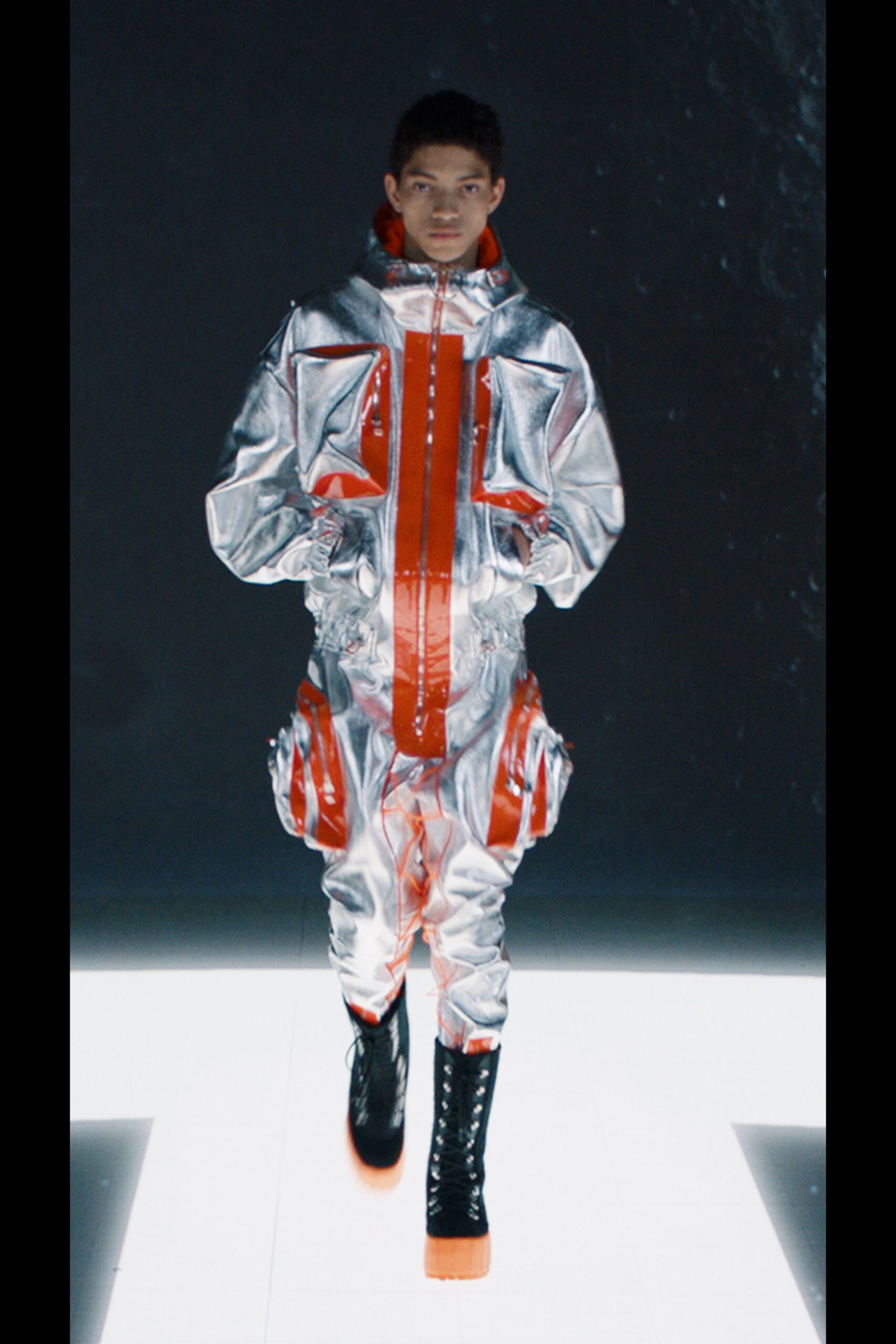 silver vinyl jumpsuit with orange accents