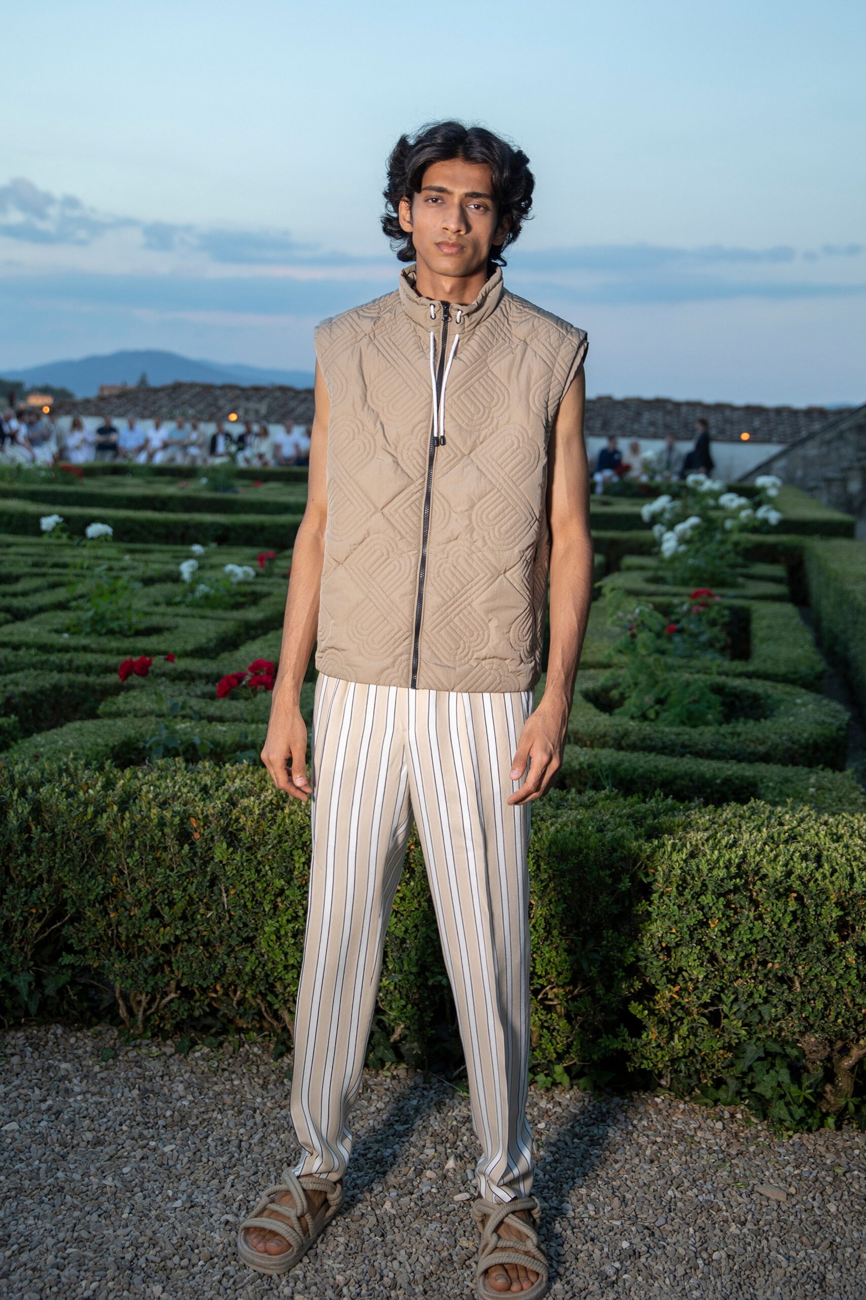 beige quilted vest and striped pants