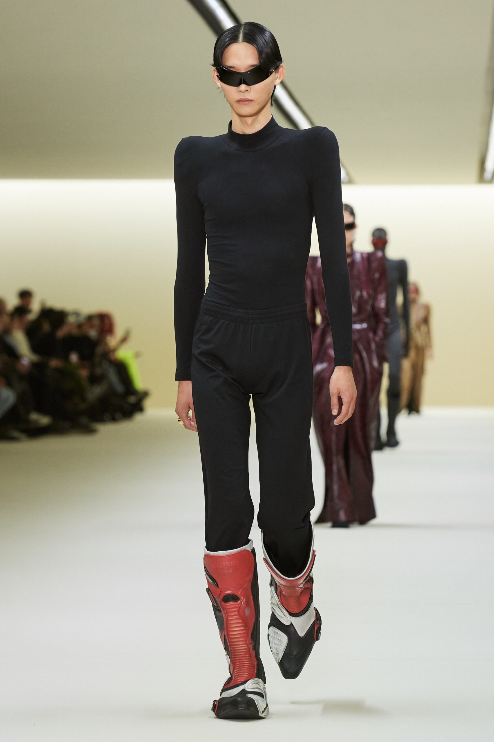 black fitted catsuit with red boots