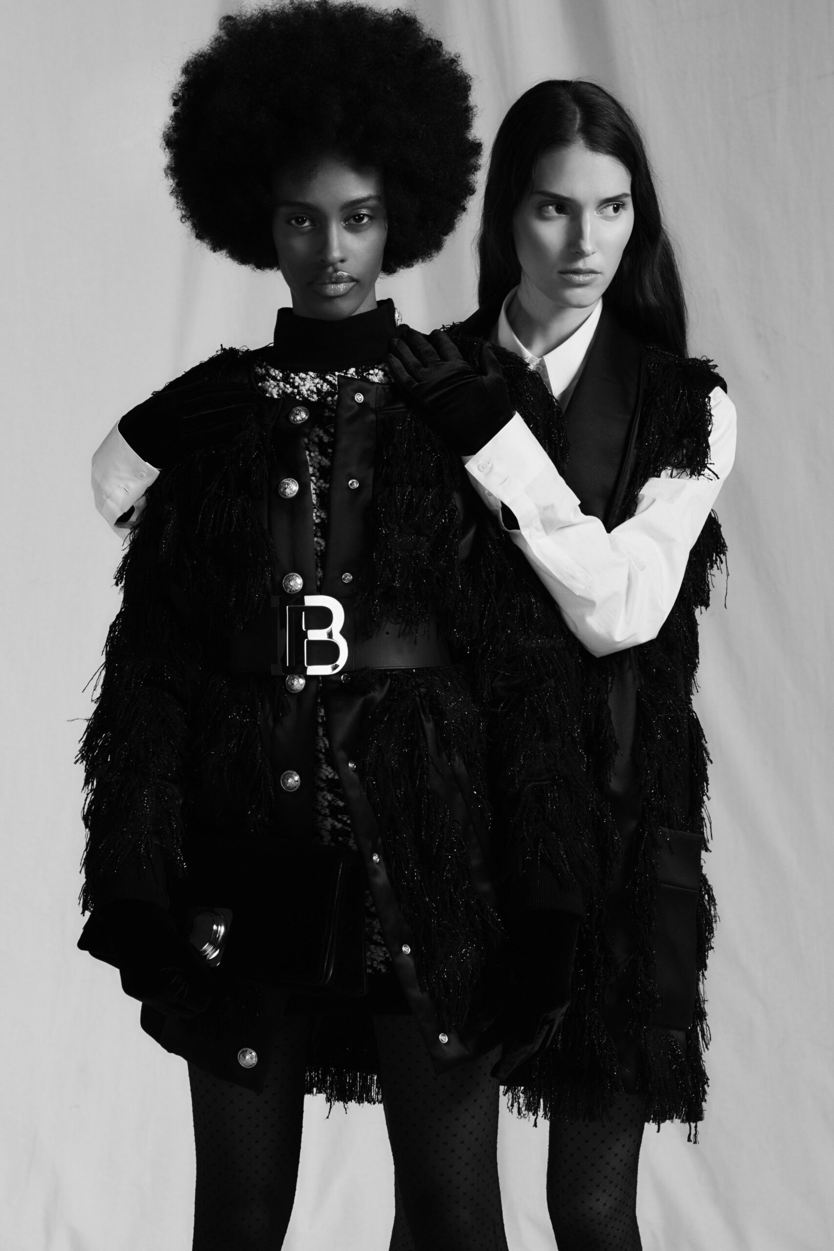 black fringed coat and white shirt