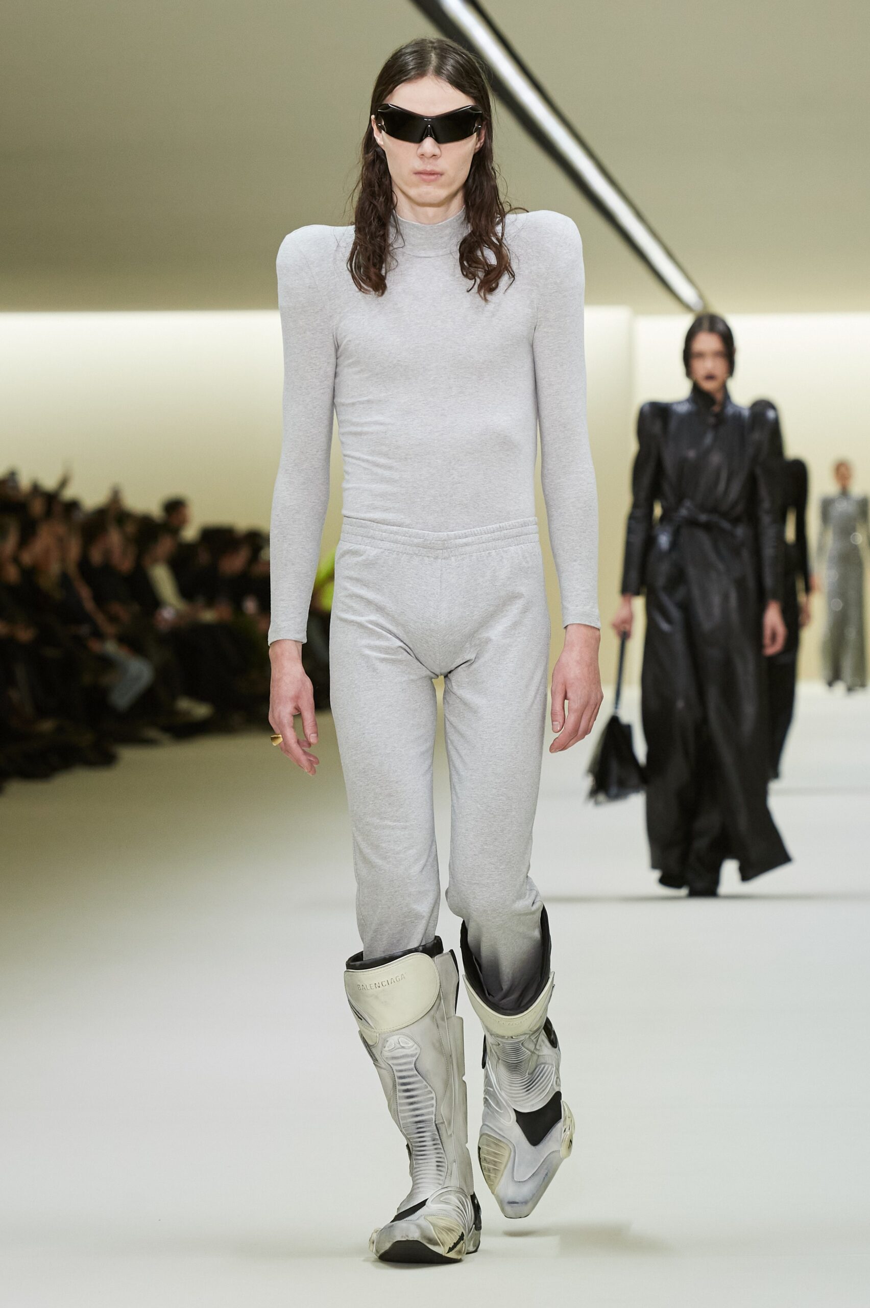 gray fitted catsuit with white boots