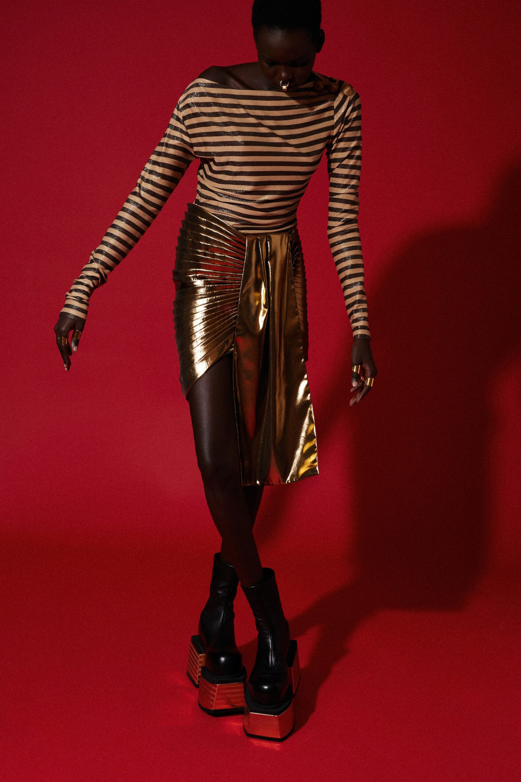 striped off-shoulder top with gold skirt