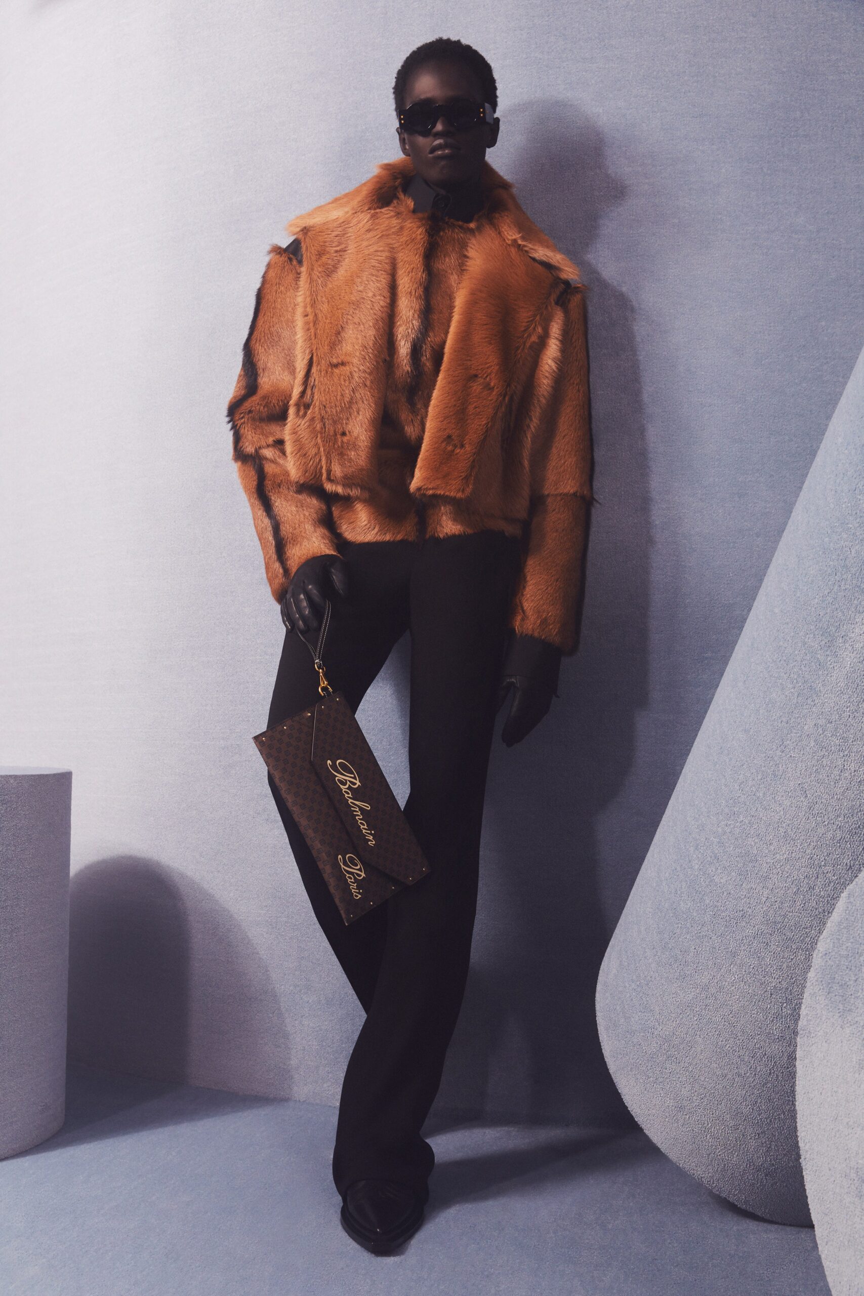 orange faux-fur coat with black pants