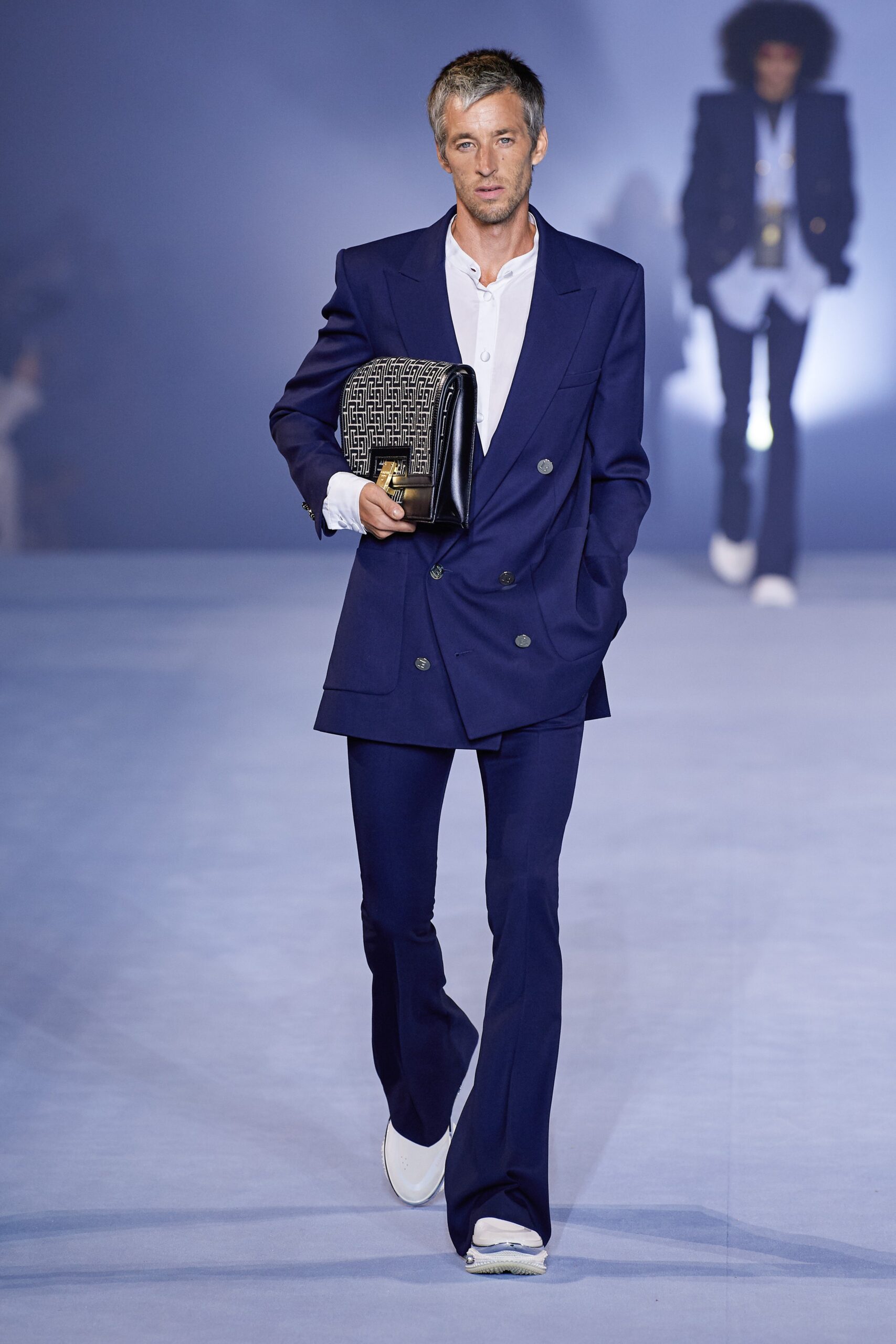 blue tailored suit with white shoes