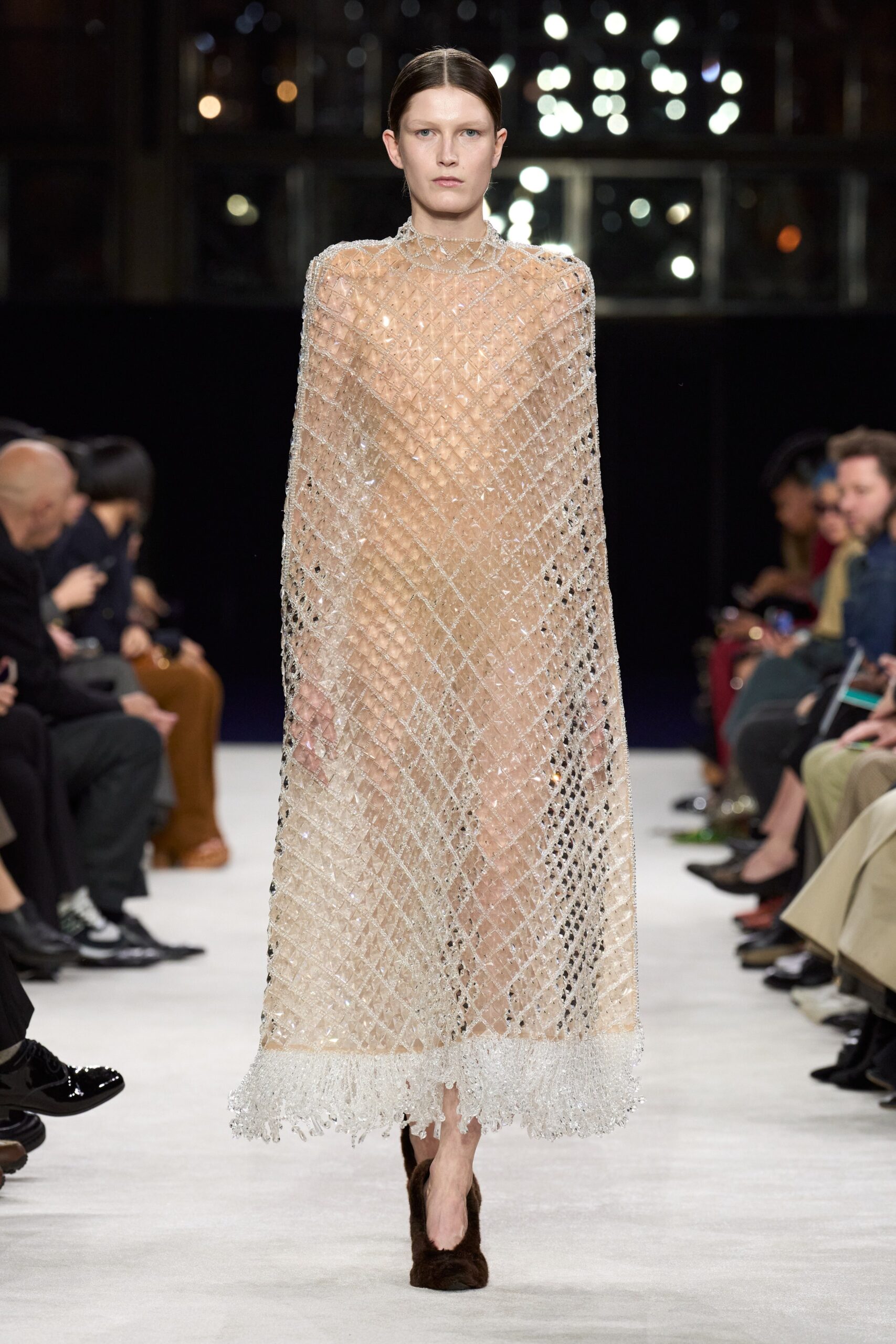clear sequined cape over beige dress