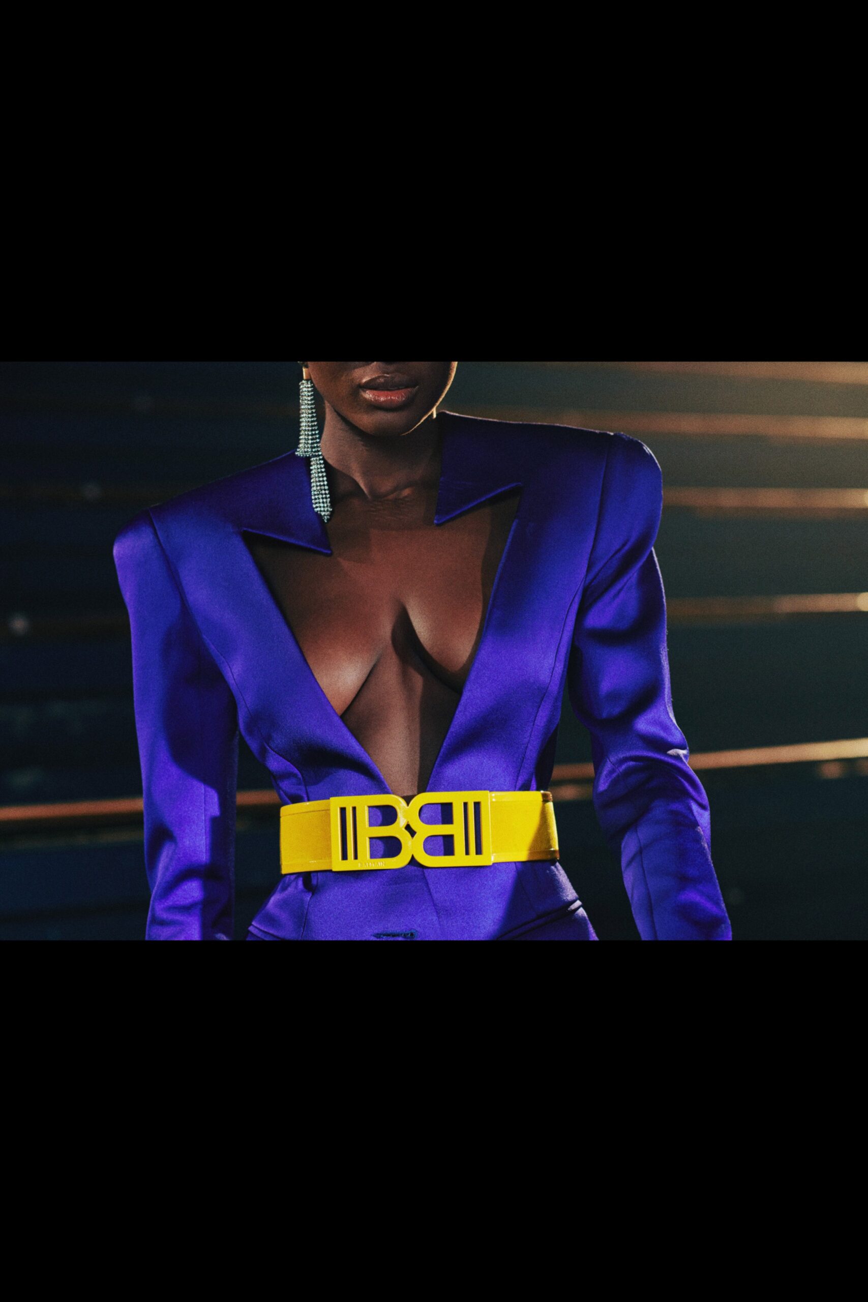 fitted purple blazer with yellow belt