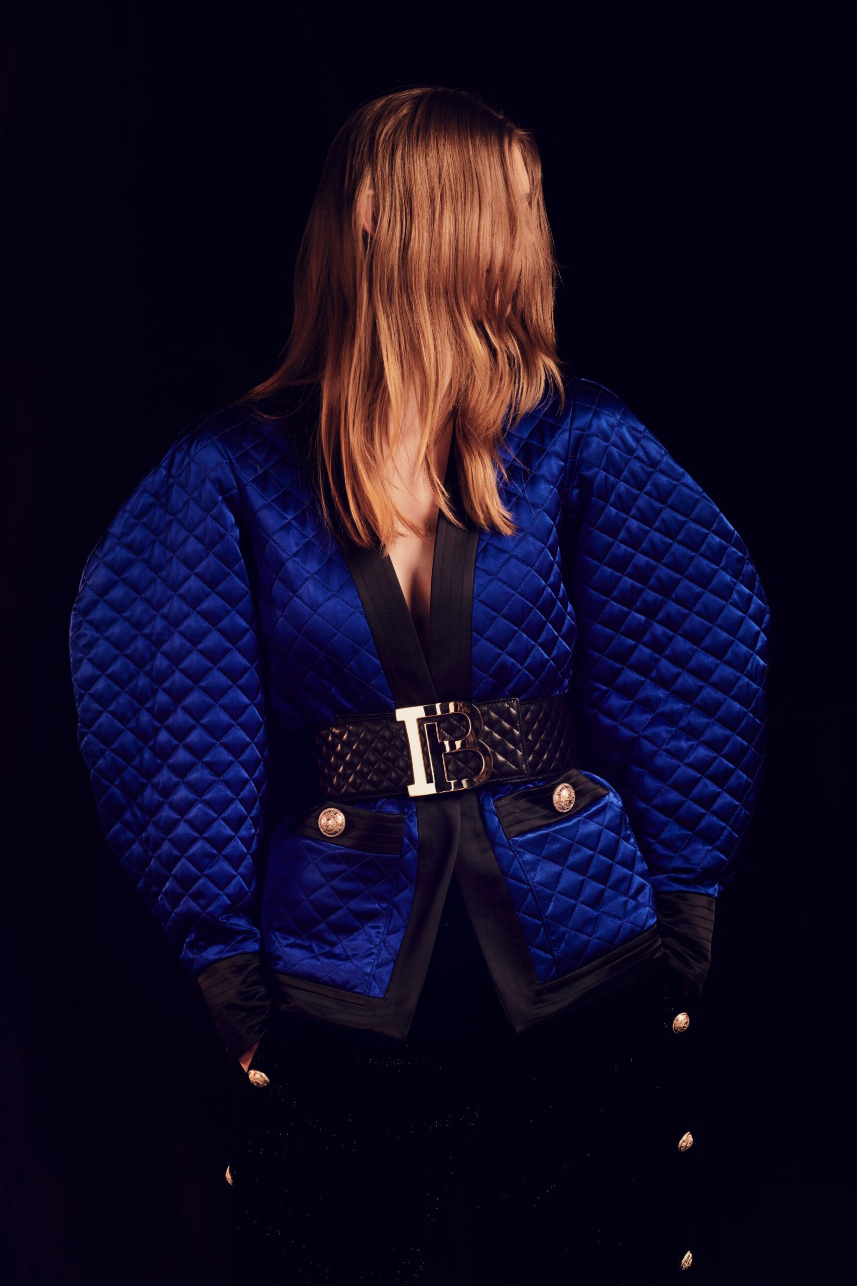 blue quilted jacket with black belt