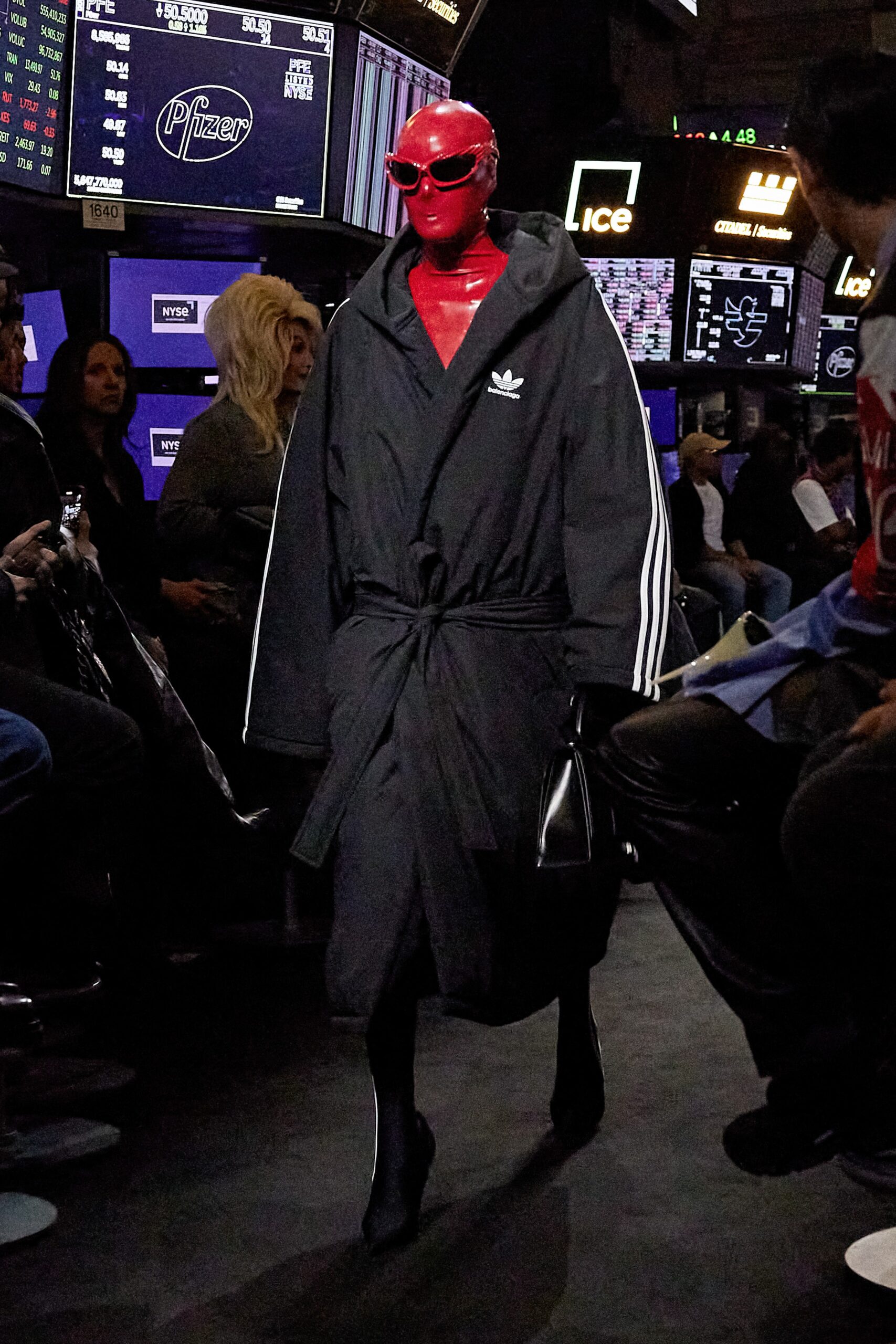 black relaxed coat with red sunglasses