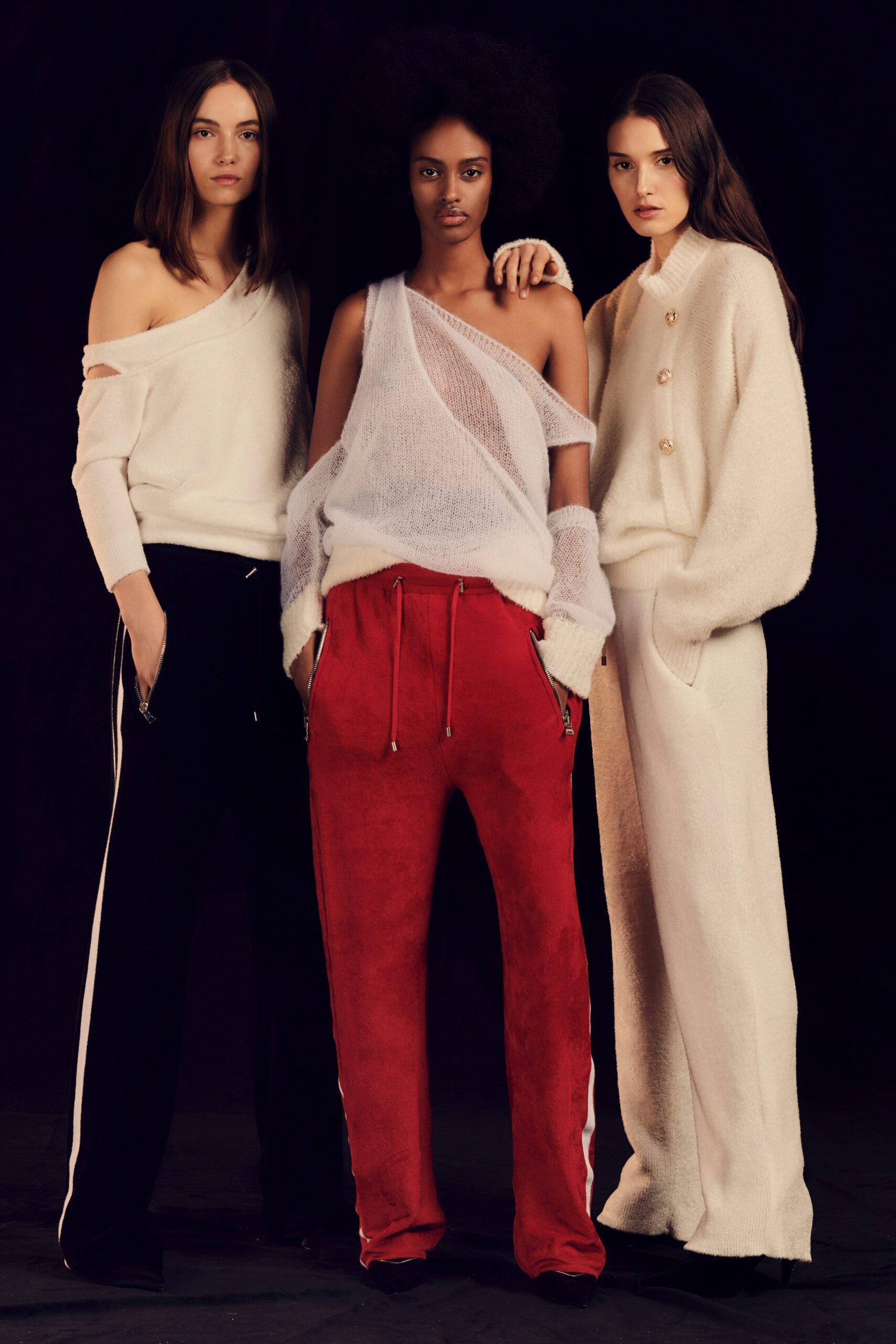 white off-shoulder sweater and black pants