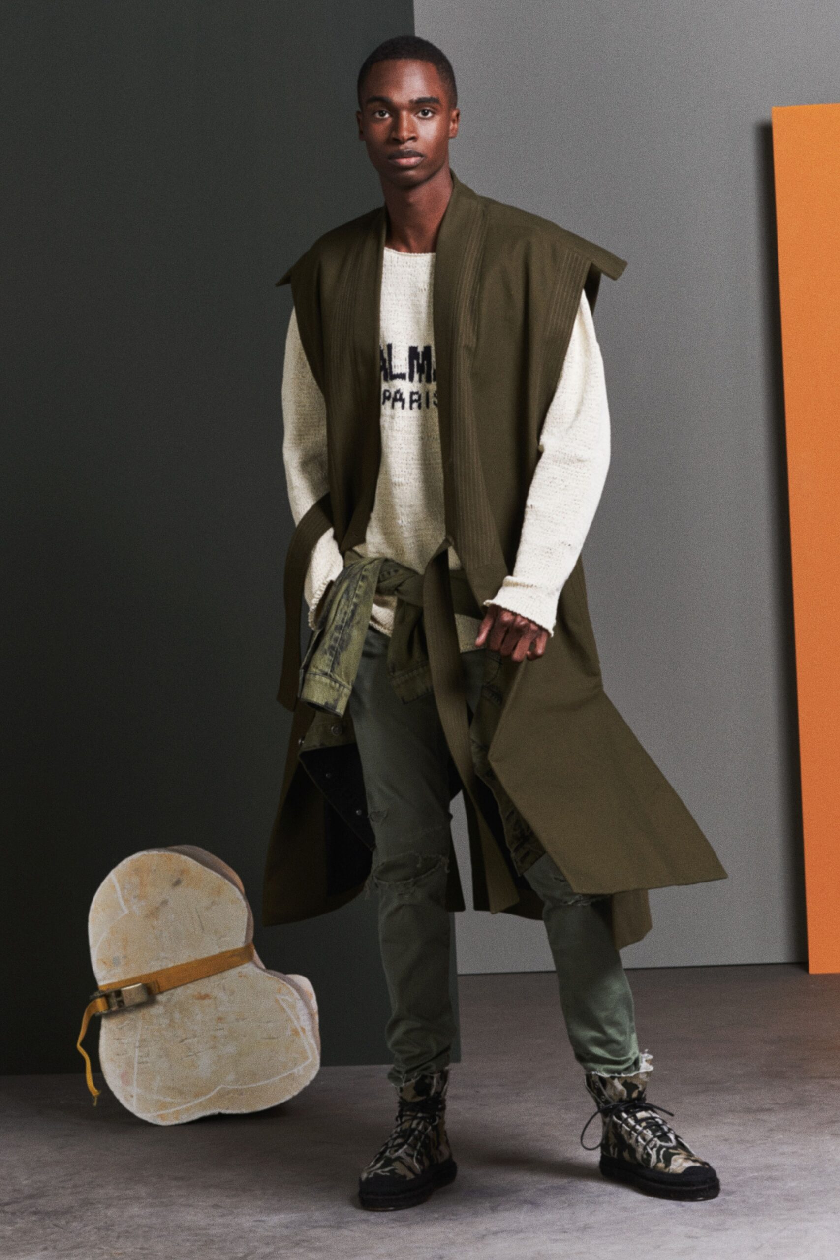green coat white sweater cargo pants