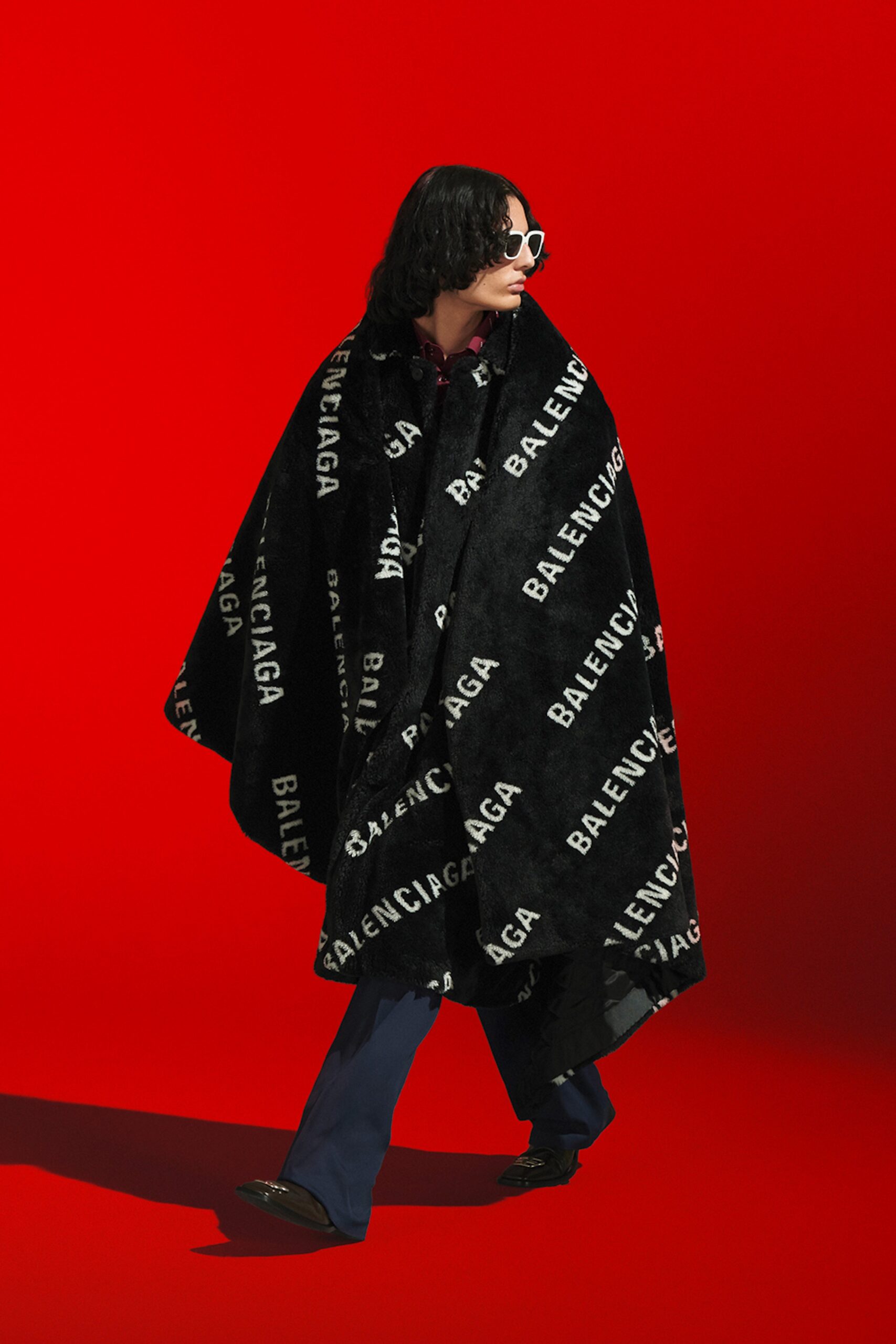 black faux-fur cape with printed details