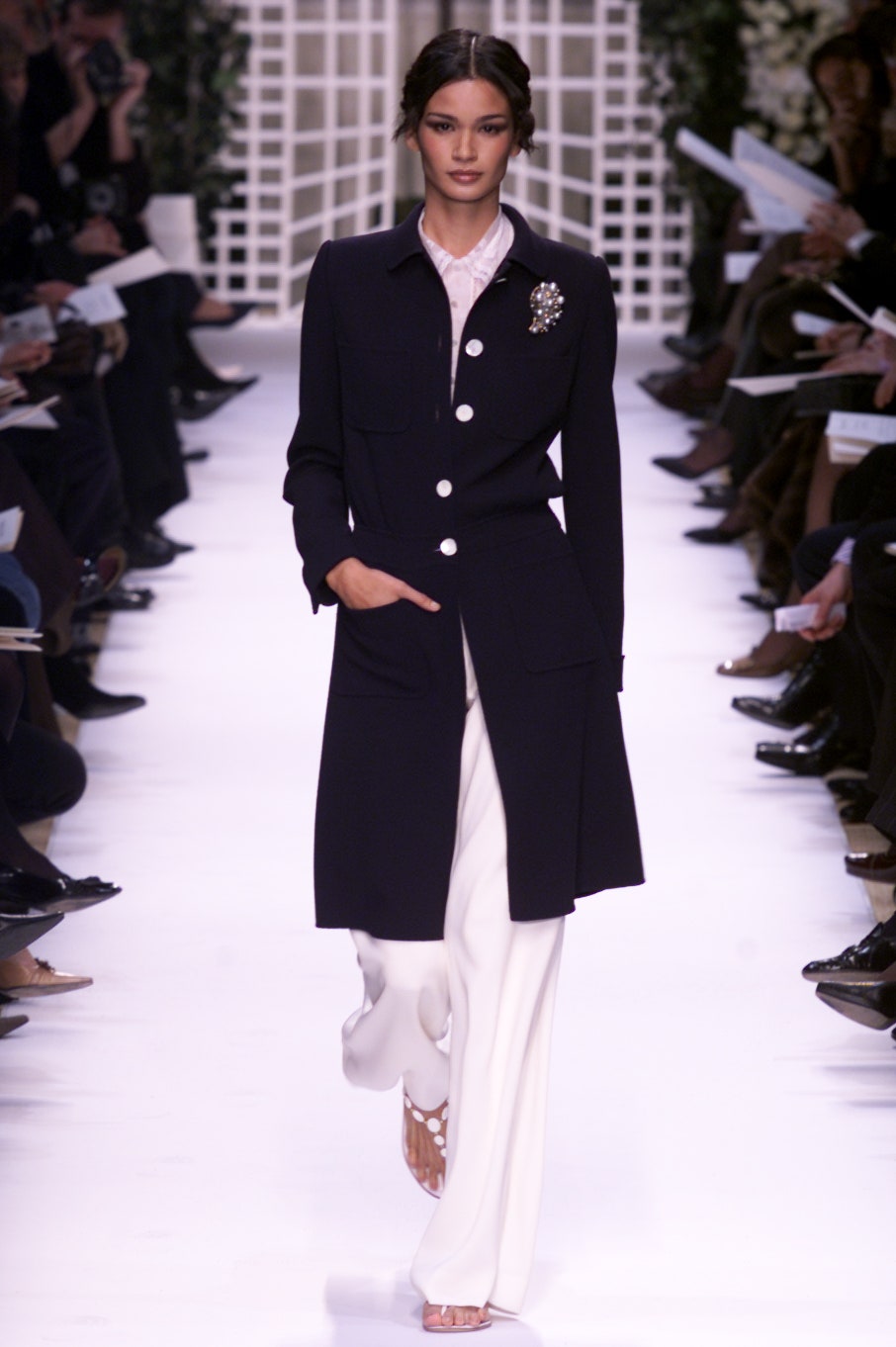 black wool fitted coat and white tailored pants