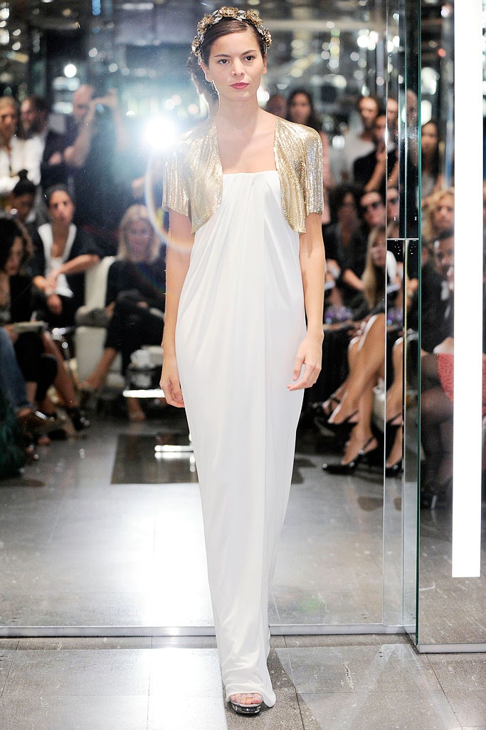 white silk draped gown with gold cape