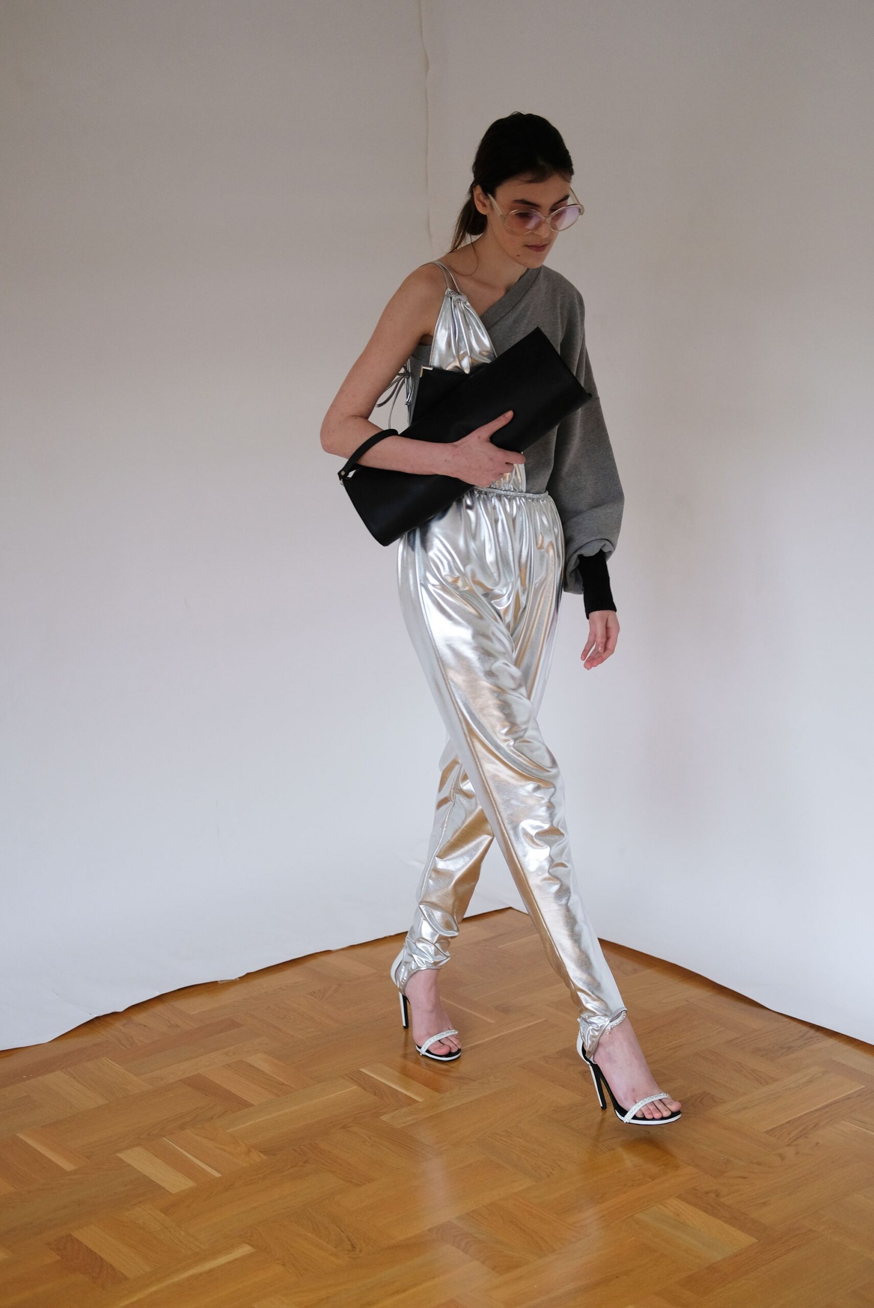 silver metallic jumpsuit with gray sweater