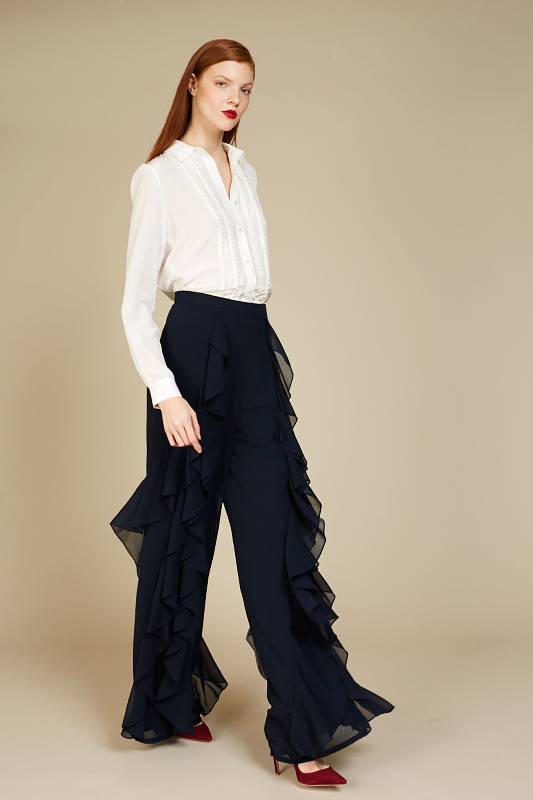 white fitted shirt with navy ruffled pants