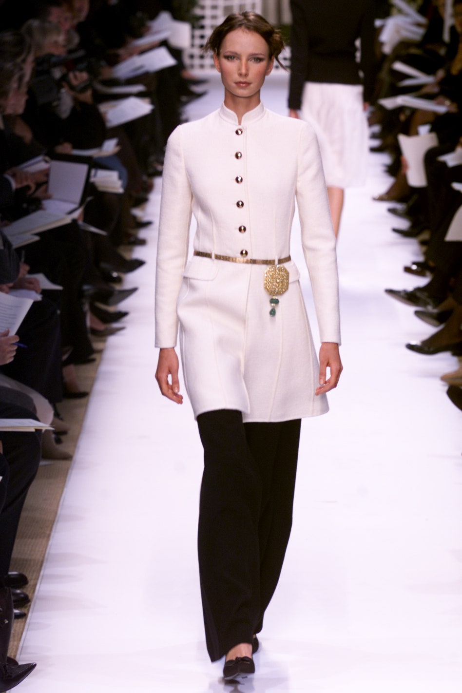white fitted coat and black tailored pants