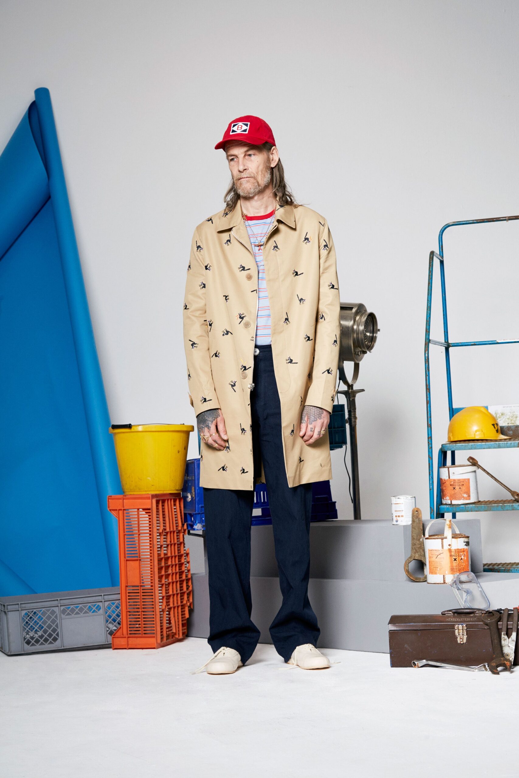 beige printed coat with navy pants