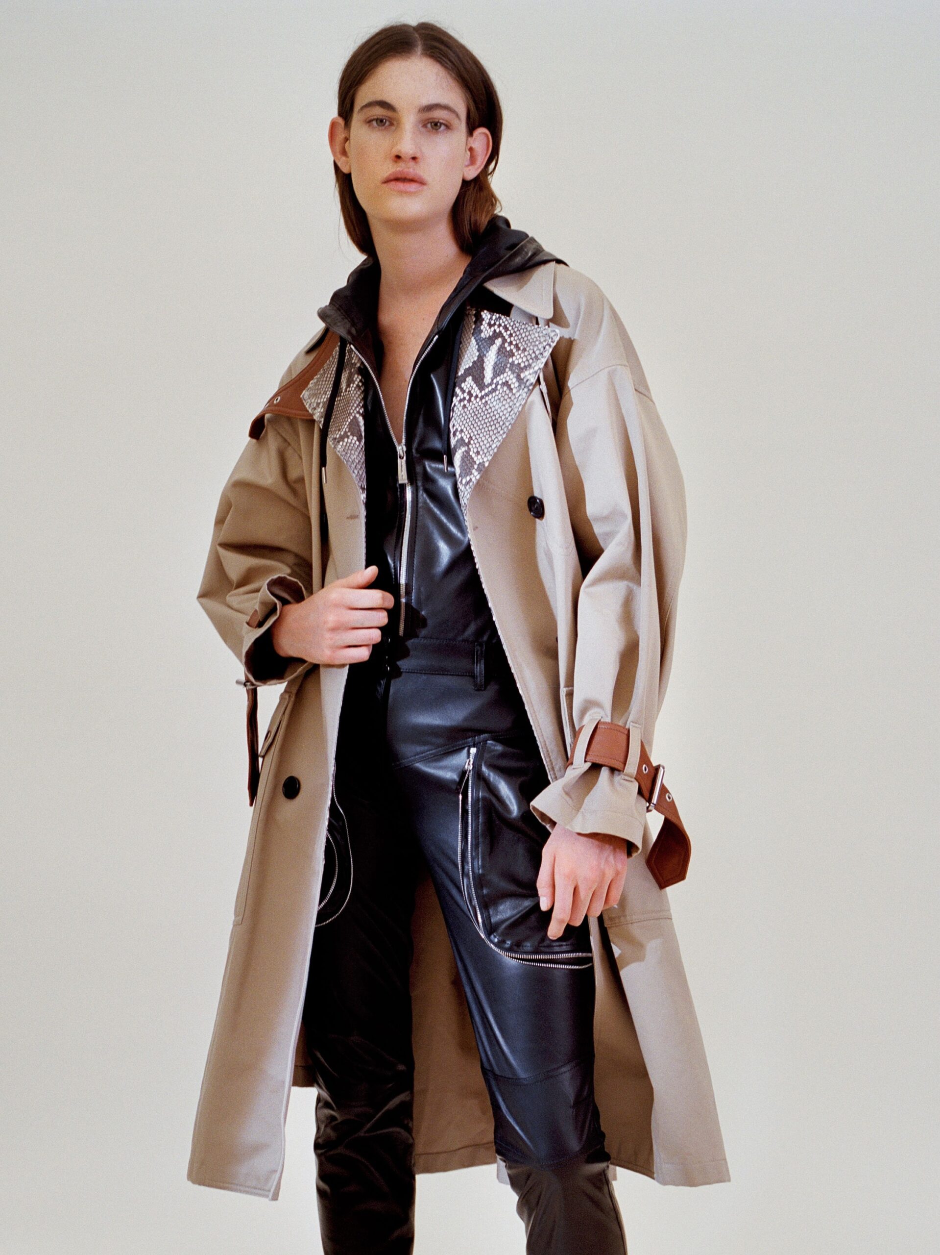 beige trench coat with black catsuit