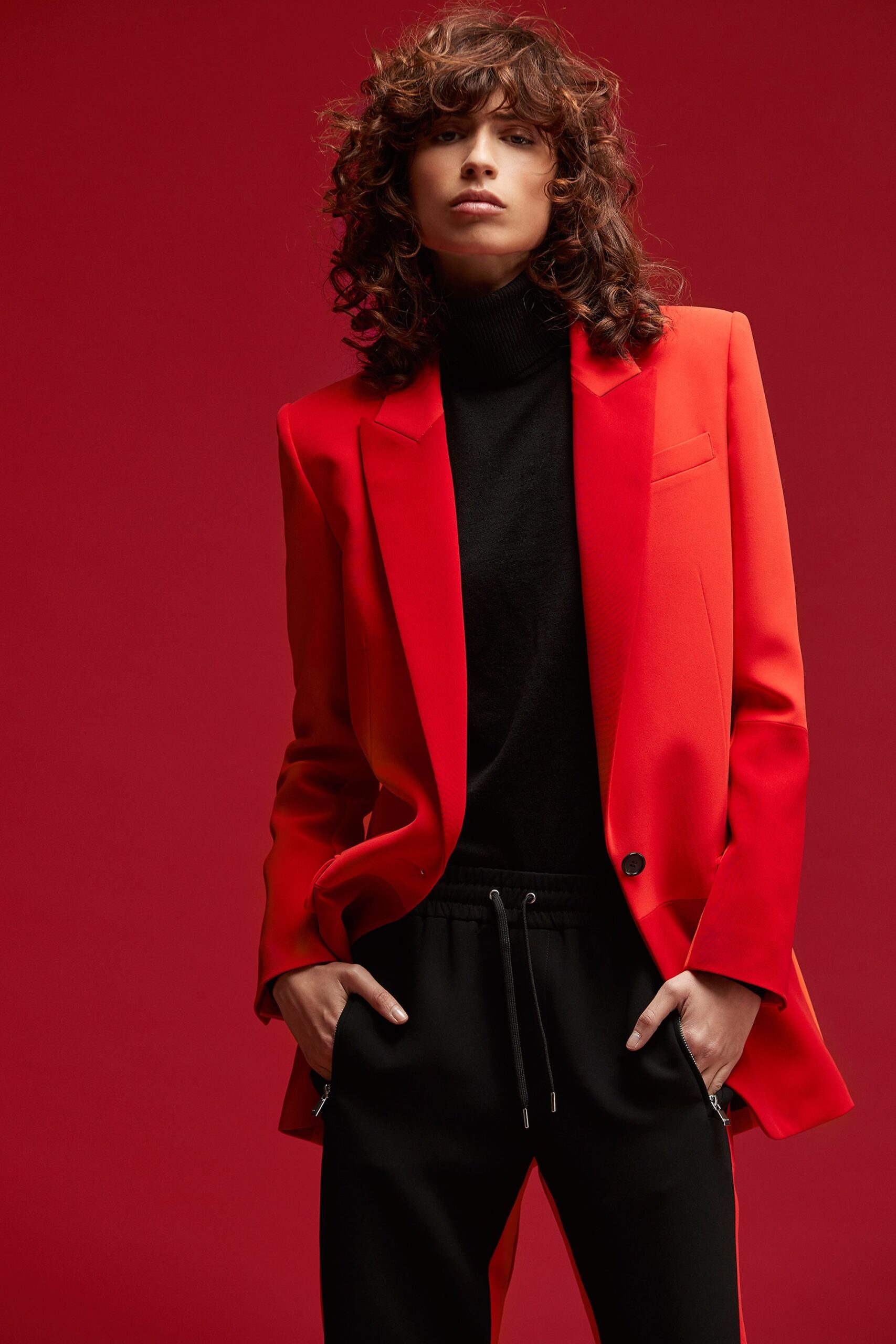 red structured blazer with black top