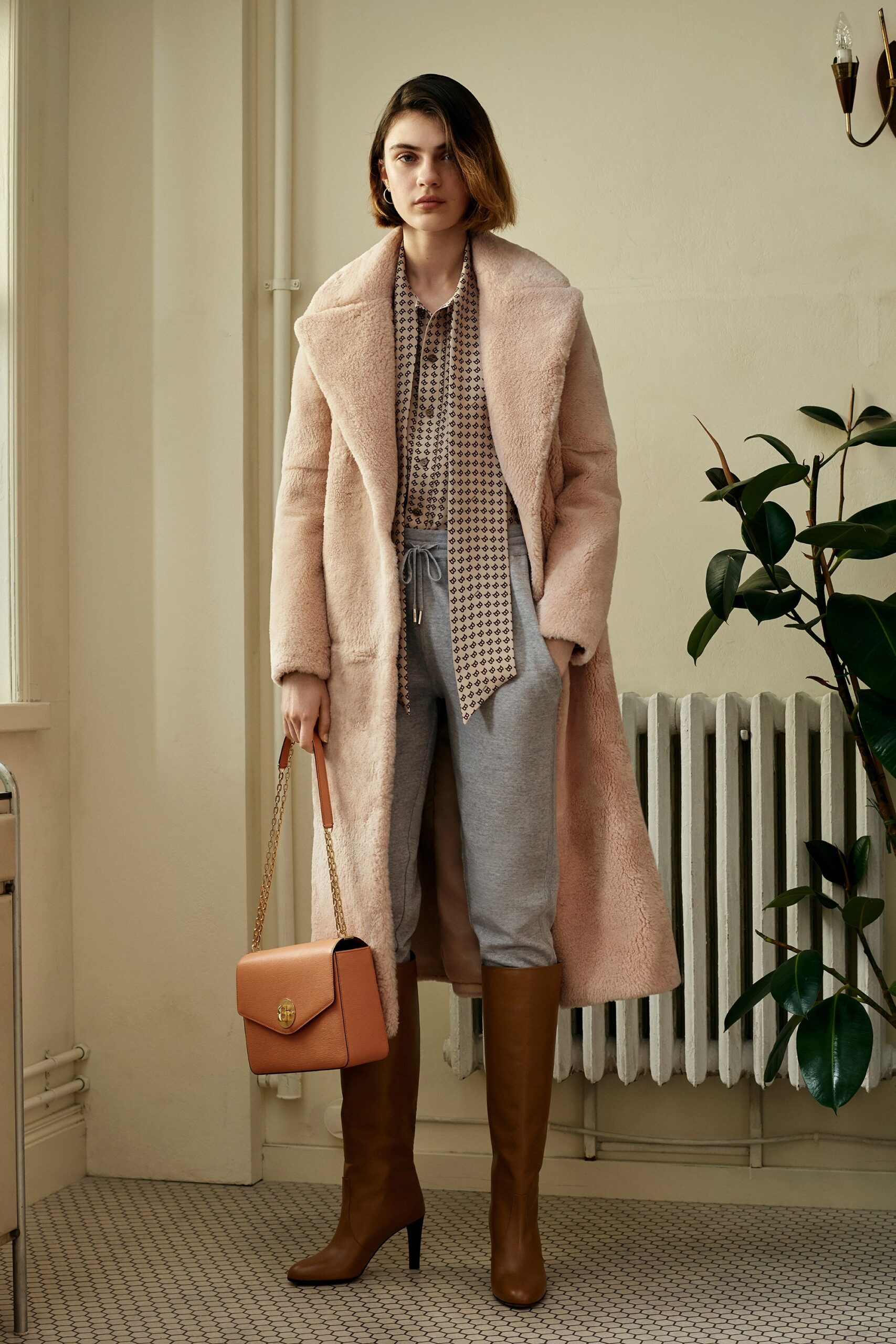 pink faux-fur coat with beige blouse