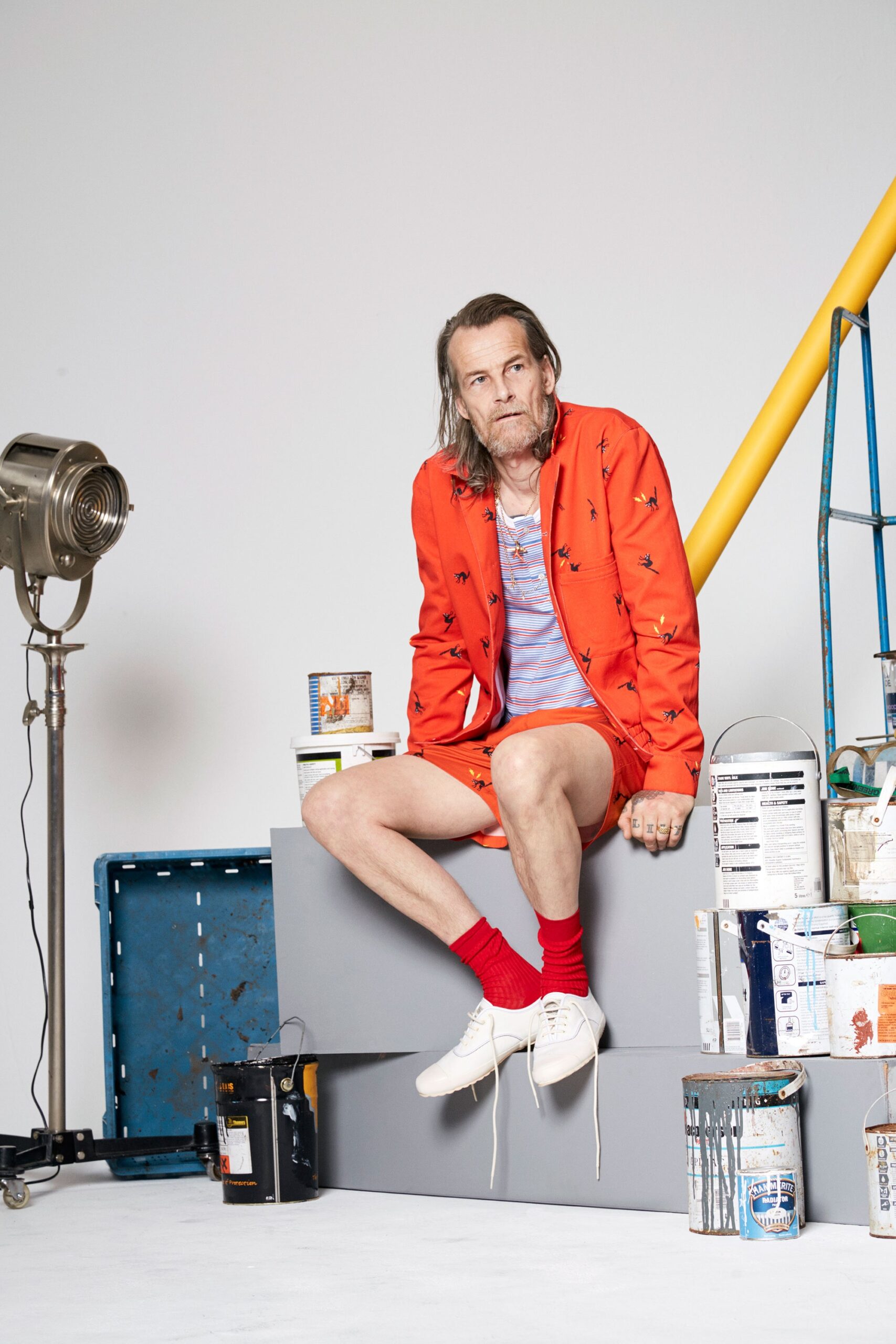 orange jacket blue shirt white shorts