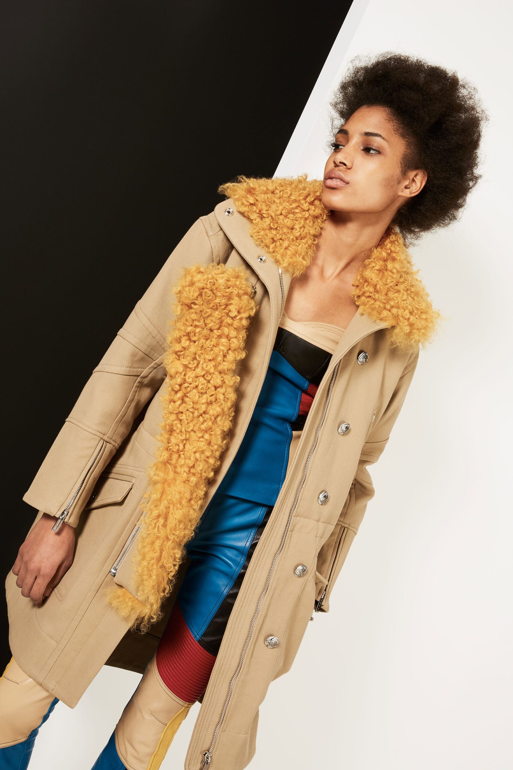beige coat with black top and blue pants