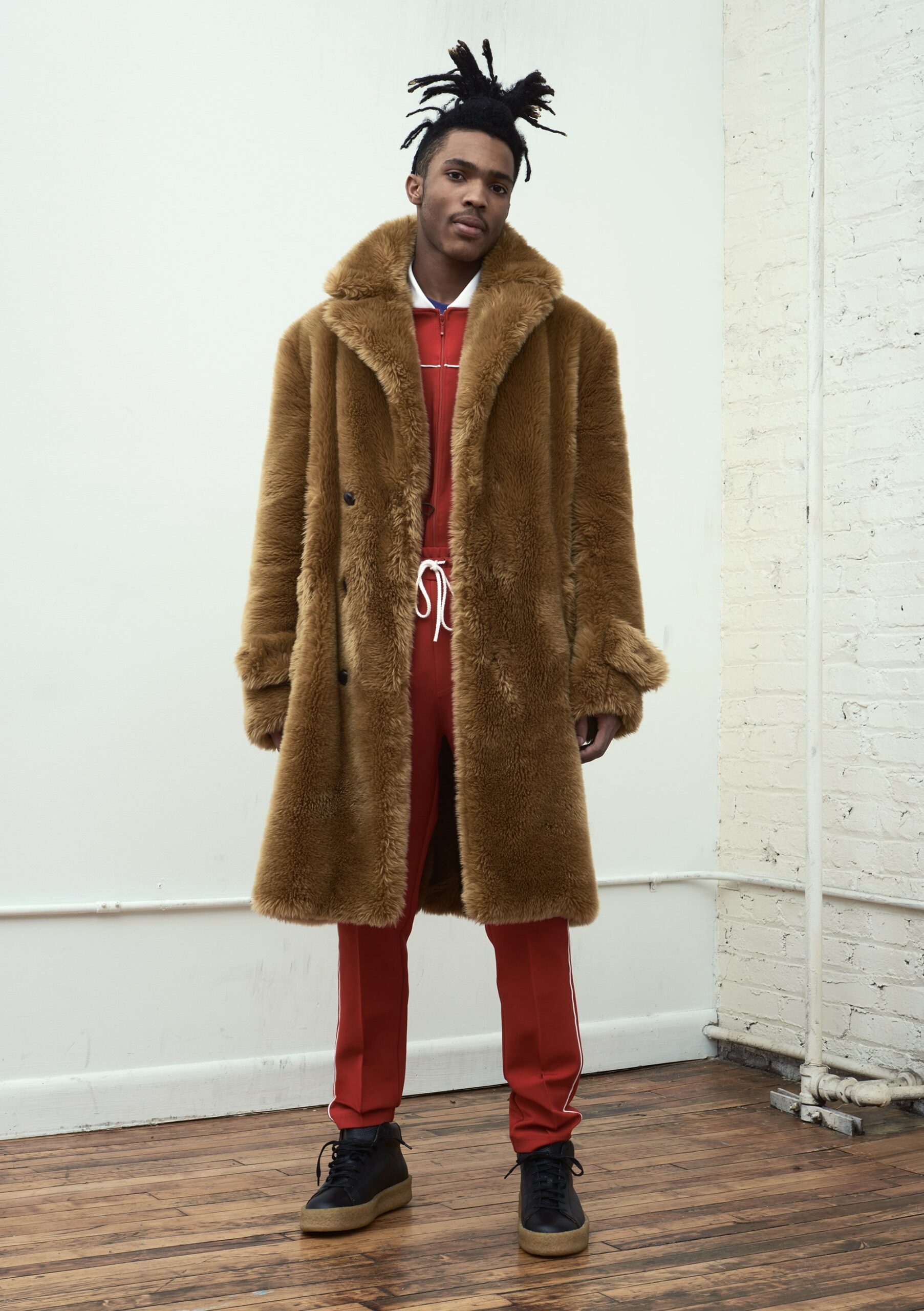 brown faux-fur coat with red jumpsuit