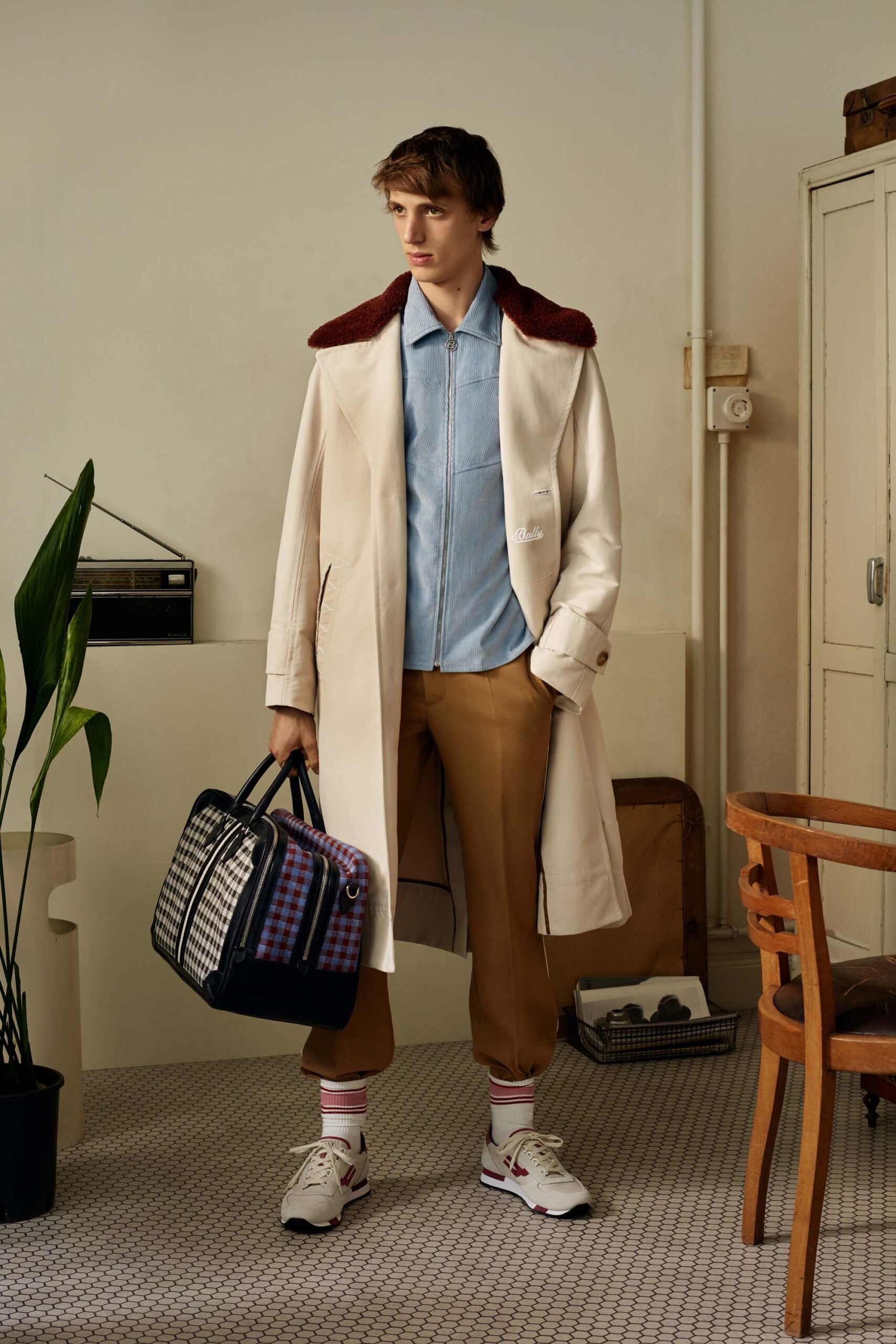 white coat blue shirt beige pants