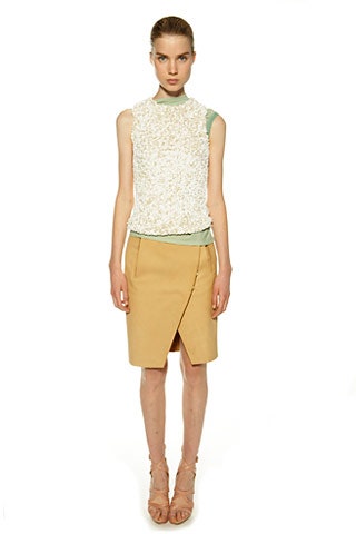 white embroidered sleeveless top and beige pencil skirt